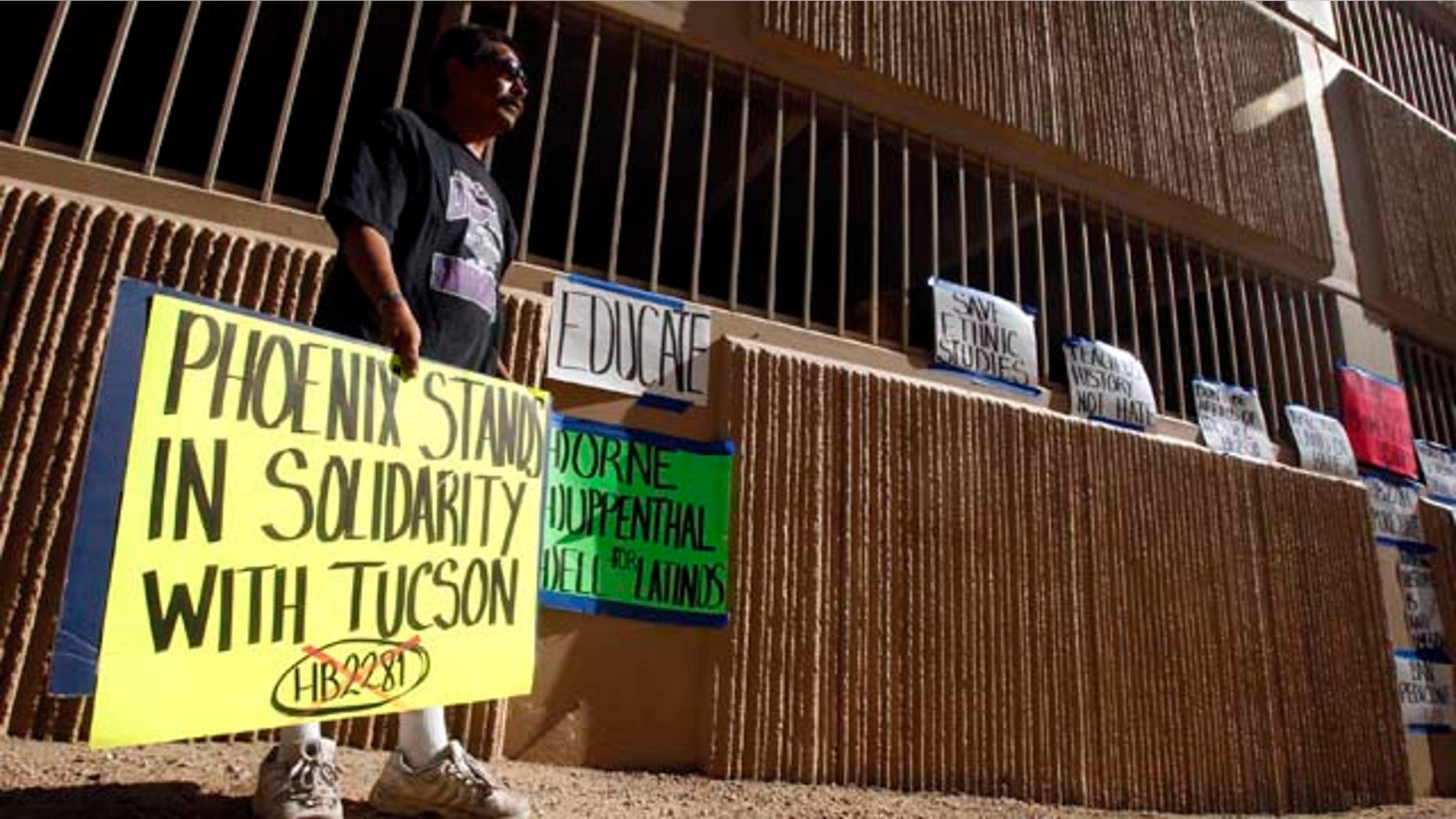 Juan Lopez, of Phoenix, shows his support of the Tucson Unified School District, after Superintendent of Public Instruction John Huppenthal announces that the Tucson Unified School District violates state law by teaching its Mexican American Studies Department's ethic studies program at a news conference at the Arizona Department of Education Wednesday, June 15, 2011, in Phoenix. (AP Photo/Ross D. Franklin)