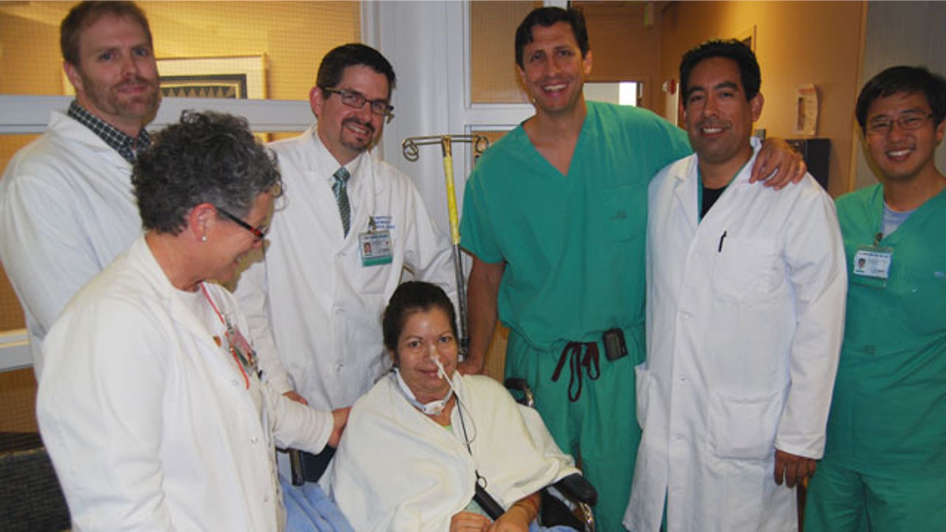 Brenda Charett Jensen surrounded by her surgical team