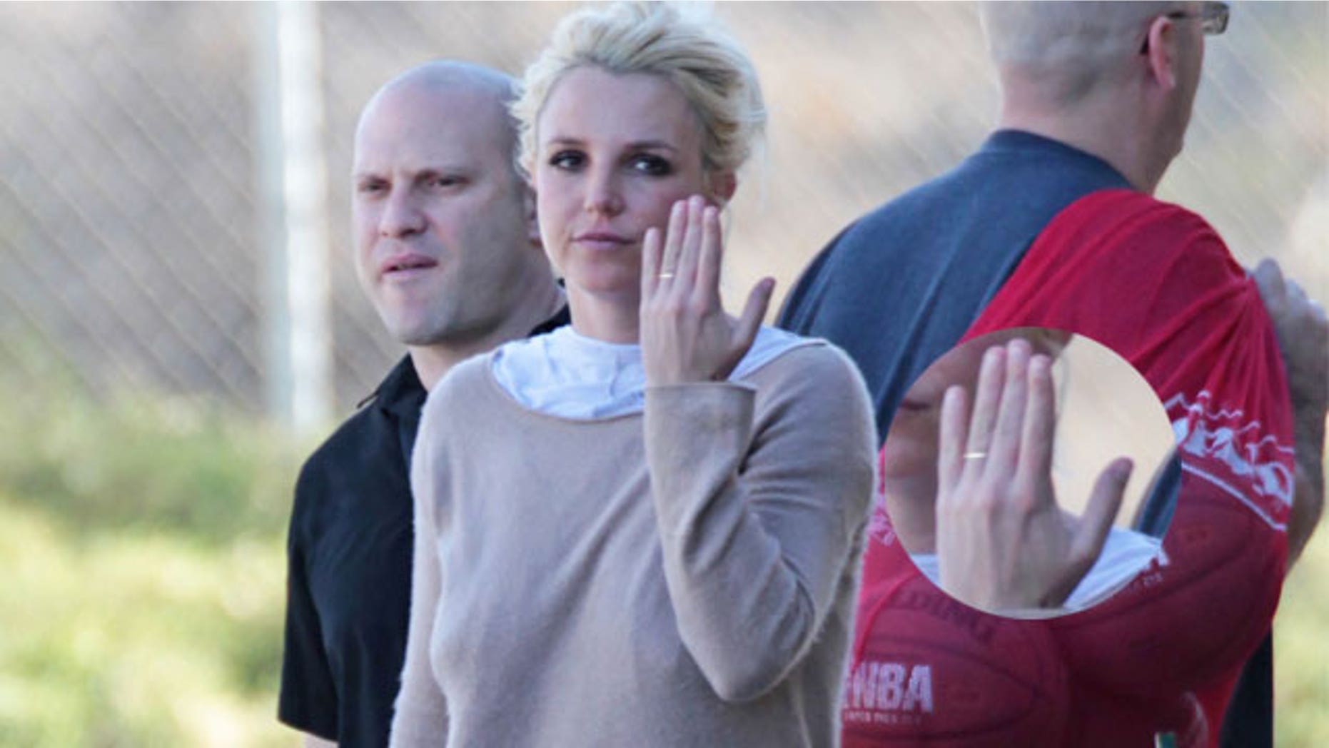 January 25, 2014. Britney Spears flashing a thin gold band on wedding ring finger at her son's soccer match.