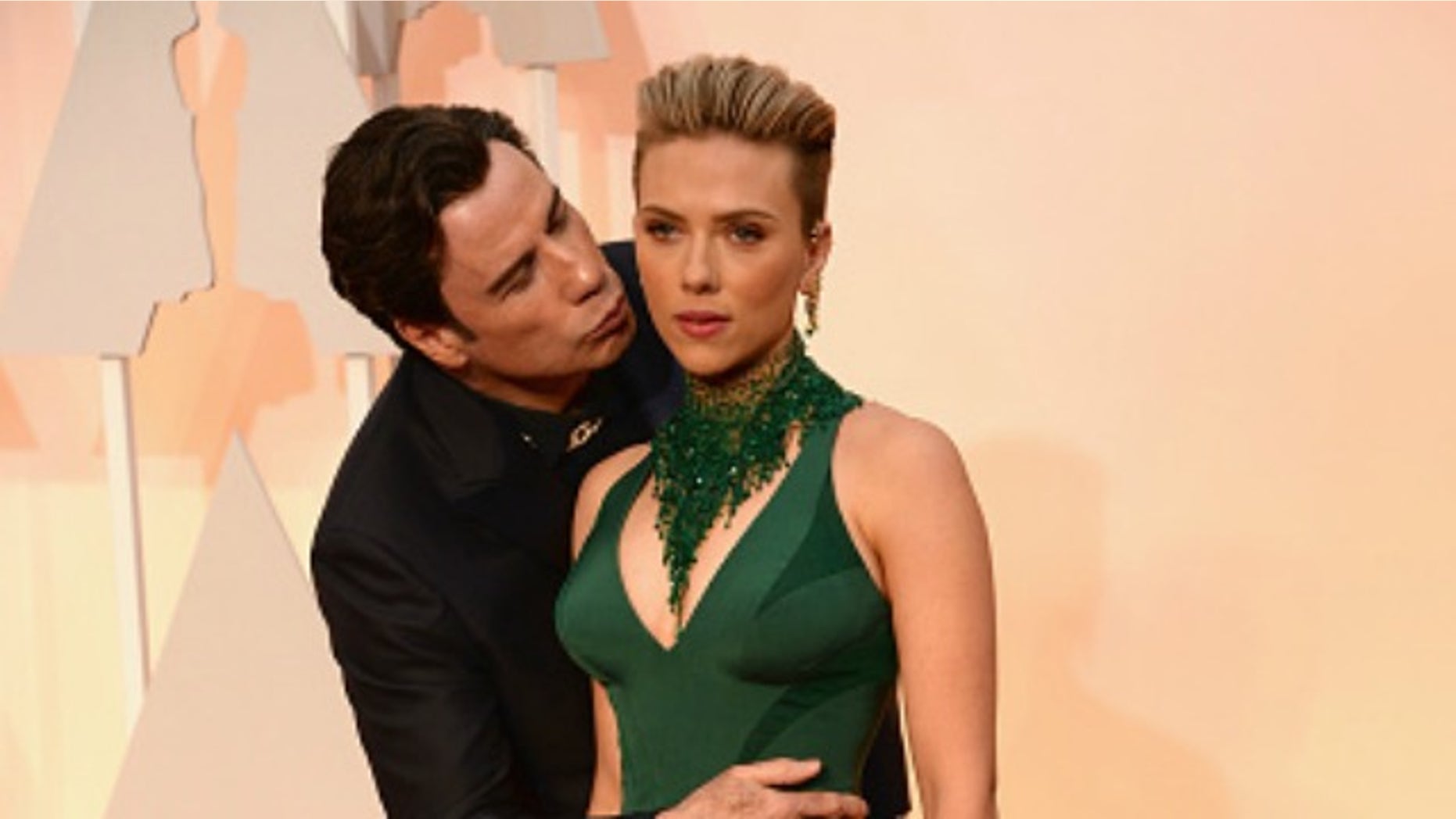 HOLLYWOOD, CA - FEBRUARY 22: Actor John Travolta (L) and actress Scarlett Johansson attend the 87th Annual Academy Awards at Hollywood & Highland Center on February 22, 2015 in Hollywood, California. (Photo by Kevin Mazur/WireImage)