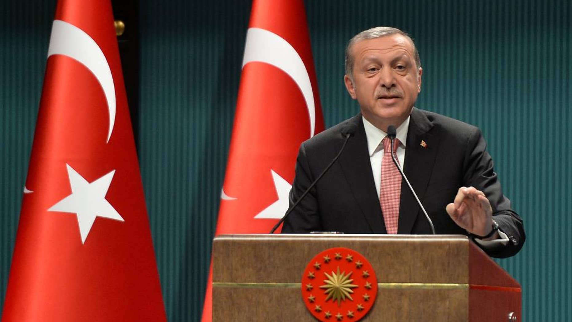 FILE - This is a Wednesday, July 20, 2016 file photo of Turkey's President Recep Tayyip Erdogan as he speaks after an emergency meeting of the government in Ankara, Turkey. Erdogan hinted on Thursday Sept. 29, 2016 that the three-month state of emergency declared following the failed July 15 coup could be extended to over a year, a day after the national security council recommended it be extended for another three months. (AP Photo/File)