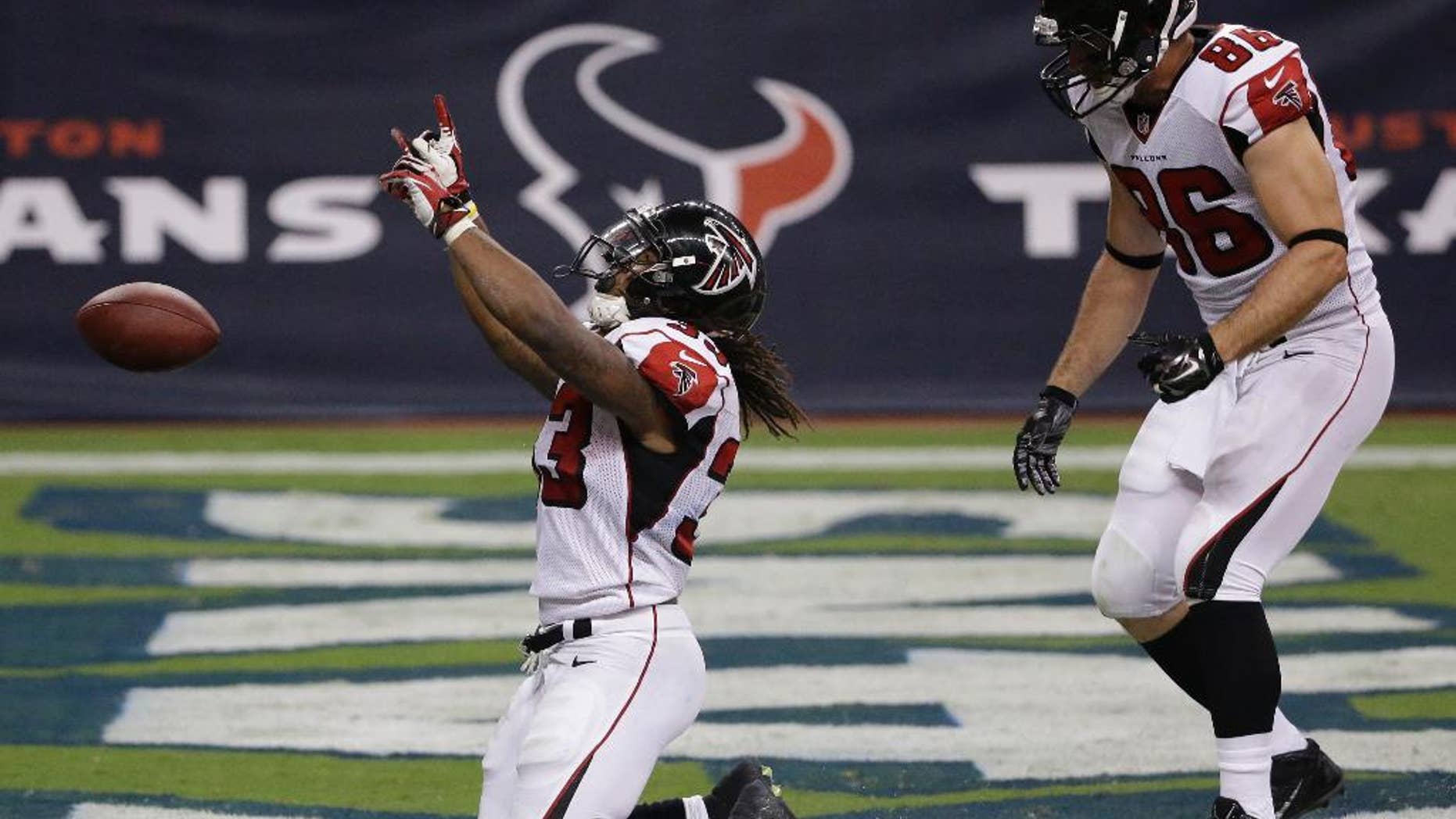 Atlanta Falcons' Devonta Freeman (33) celebrates after he scored against the Houston Texans during the fourth quarter of an NFL preseason football game Saturday, Aug. 16, 2014, in Houston. (AP Photo/David J. Phillip)