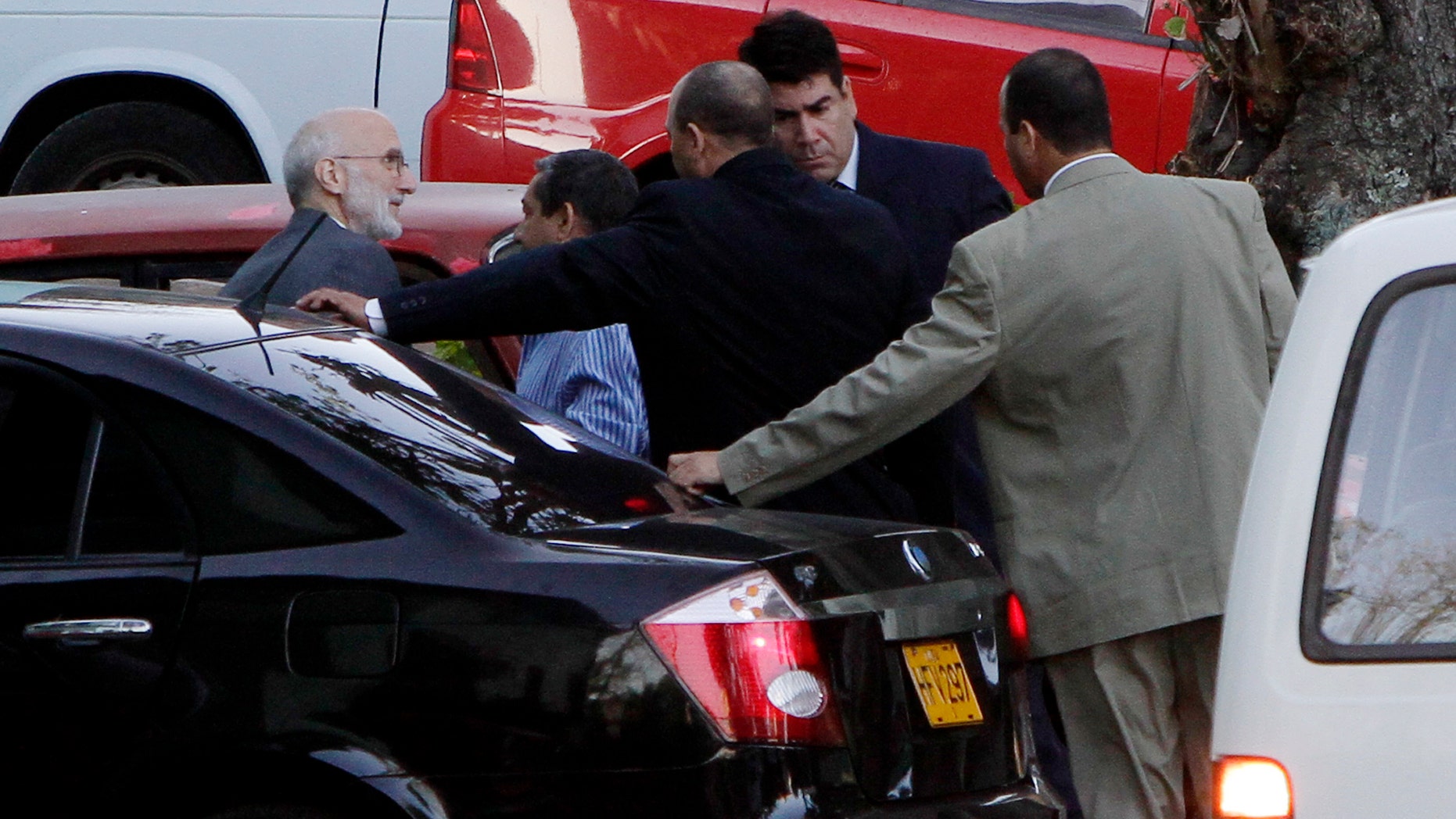 U.S. government contractor Alan Gross, left, is surrounded by security forces as he arrives for his trial in Havana, Cuba. Gross, a 61-year-old Maryland native, was arrested in December 2009 and charged with undermining Cuba's government by bringing communications equipment onto the island illegally.