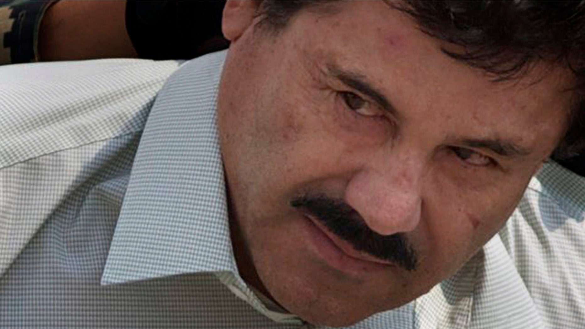 FILE - In this Feb. 22, 2014 file photo, Joaquin 'El Chapo' Guzman is escorted to a helicopter in handcuffs by Mexican Navy marines at a navy hanger in Mexico City. (AP Photo/Eduardo Verdugo, File)