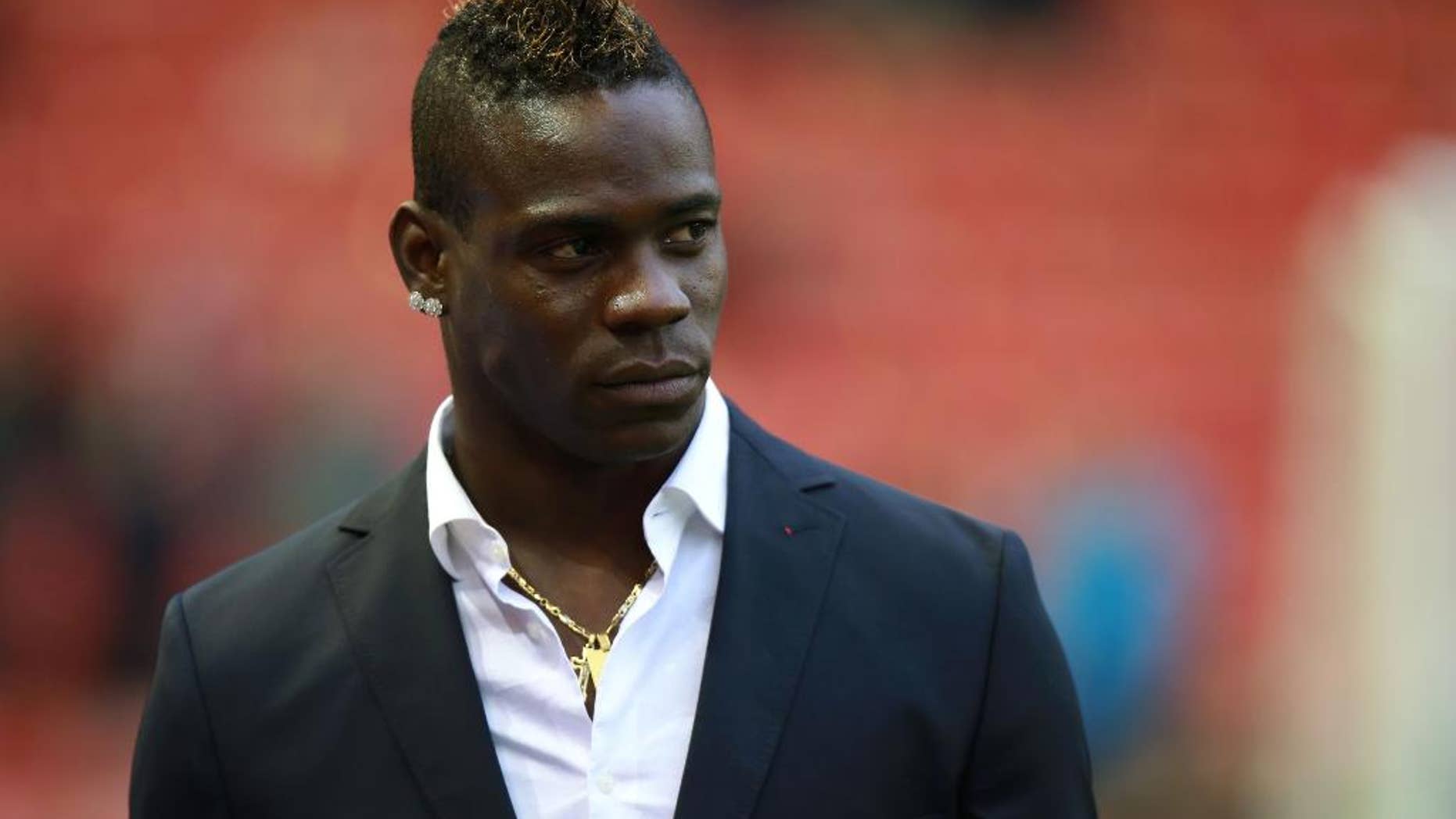Liverpool's Mario Balotelli stands at the side of the pitch prior to the English Premier League soccer match between Liverpool and Stoke City at Anfield, Liverpool, England, Saturday Nov. 29, 2014. (AP Photo/PA, Peter Byrne) UNITED KINGDOM OUT
