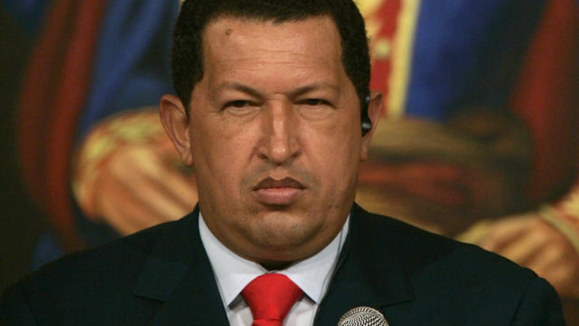 Venezuelan President Hugo Chavez gestures during a meeting with Chinese businessmen at Miraflores Palace in Caracas, Venezuela, Tuesday, Oct. 17, 2006. The picture in the background is the Venezuelan liberator Simon Bolivar. (AP Photo/Fernando Llano)