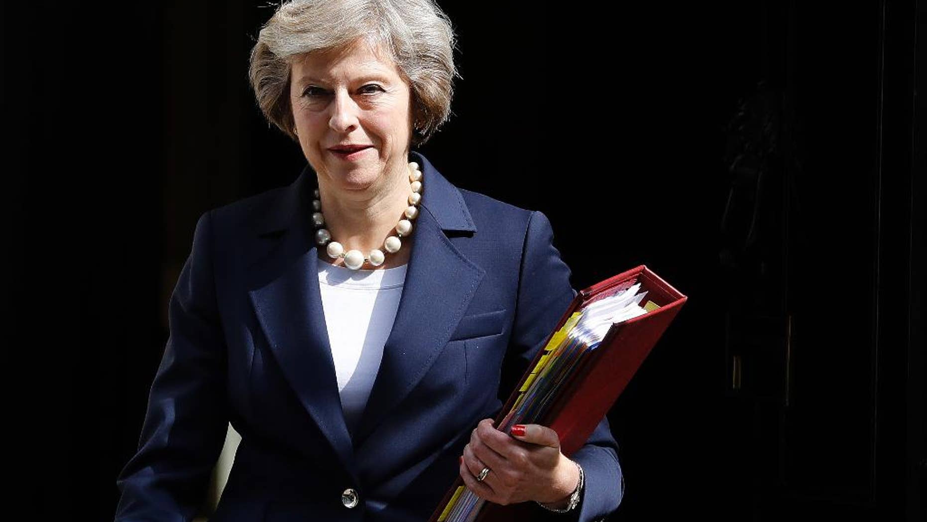 FILE - In this Wednesday, July 20, 2016 file photo, Britain's Prime Minister Theresa May leaves 10 Downing street to attend her first Prime Ministers Questions at the House of Parliament in London. Prime Minister Theresa May is attempting to allay disquiet about her surprise delay to a Chinese-backed nuclear power plant by reassuring China's leader that Britain wants strong relations with Beijing. Foreign Office Minister Alok Sharma delivered a letter from May to President Xi Jinping during a visit to Beijing. May's office did not publish the letter, but said Tuesday, Aug. 16 it was about "reassuring the Chinese of our commitment to Anglo-Chinese relations." (AP Photo/Frank Augstein, file)