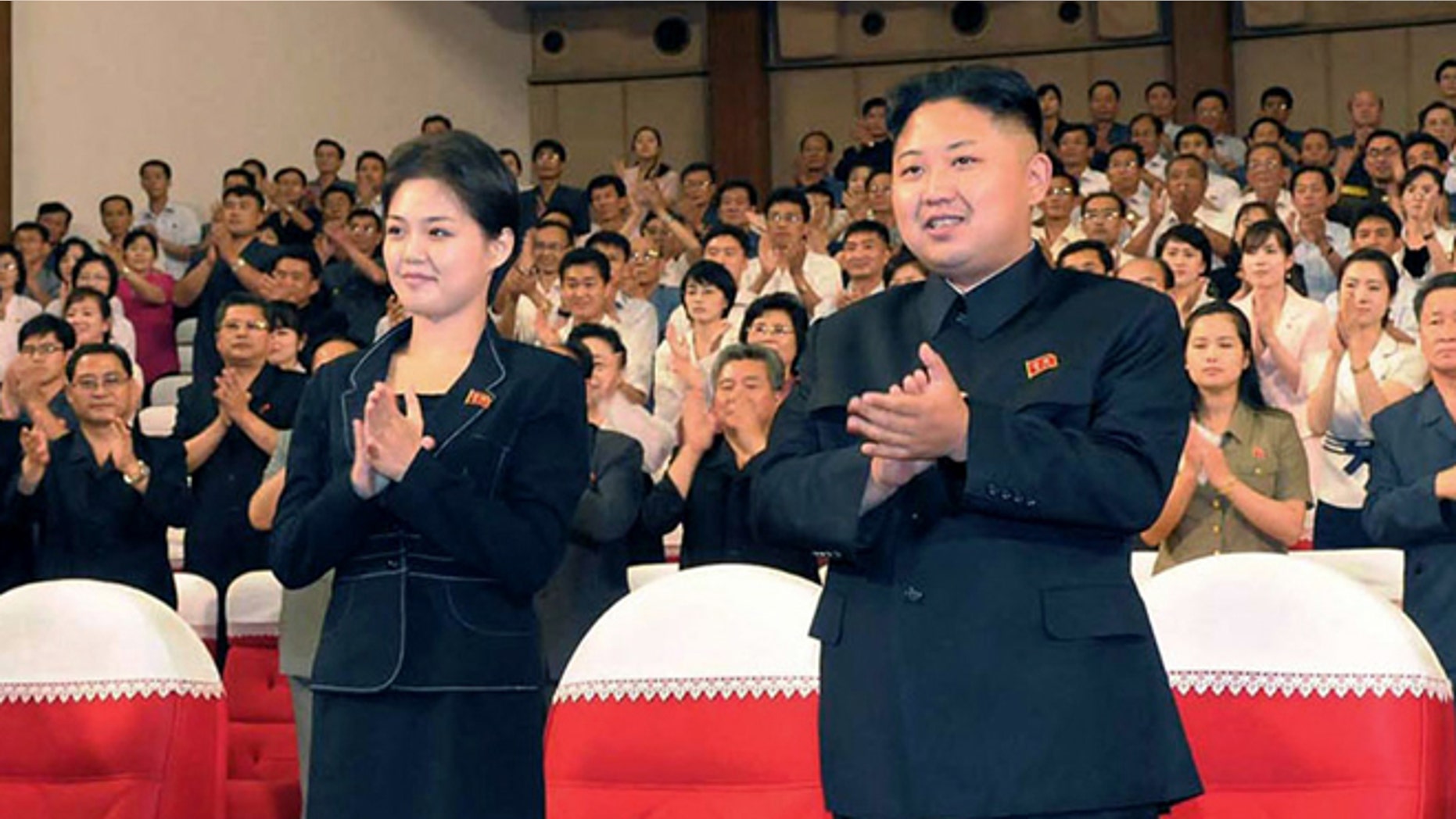 July 6, 2012: North Korean leader Kim Jong Un, center right, and wife Ri Sol-ju clap.