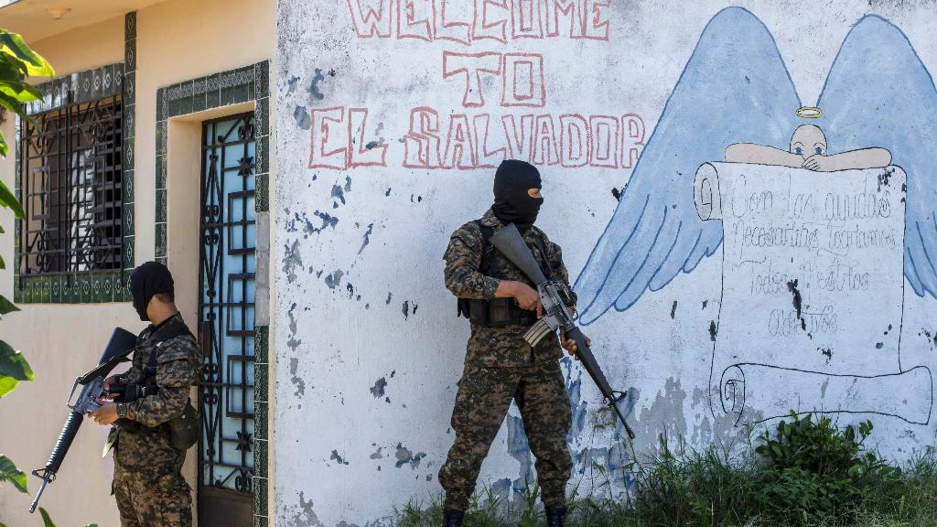 FILE - In this Aug. 31, 2015 file photo, soldiers guard a corner in a gang-controlled neighborhood in Ilopango, El Salvador. A video broadcast by local media on Saturday, March 26, 2016, purportedly made by the country’s main street gangs, is offering an end to killings, and asks the government not to continue an anti-gang offensive. Officials said they would not negotiate with the gangs. (AP Photo/Salvador Melendez, File)