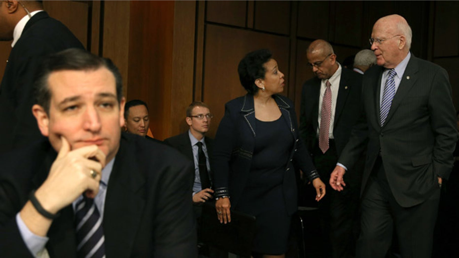 WASHINGTON, DC - JANUARY 28: Sen. Patrick Leahy (D-VT) (R) escorts Loretta Lynch back from a lunch break as Sen. Ted Cruz (R-TX) (L) sits nearby during her confirmation hearing before the Senate Judiciary Committee January 28, 2015 on Capitol Hill in Washington, DC. If confirmed by the full Senate Ms. Lynch will succeed Eric Holder as the next U.S. Attorney General. (Photo by Mark Wilson/Getty Images)