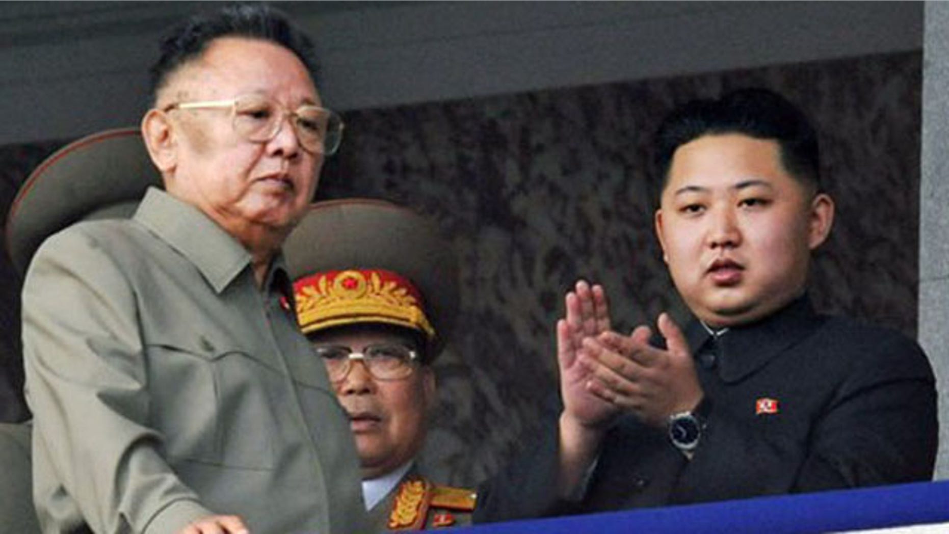 In this Oct. 10, 2010 file photo North Korea leader Kim Jong Il, left, walks by his son Kim Jong Un on the balcony as they attend a massive military parade marking the 65th anniversary of the communist nation's ruling Workers' Party in Pyongyang, North Korea.