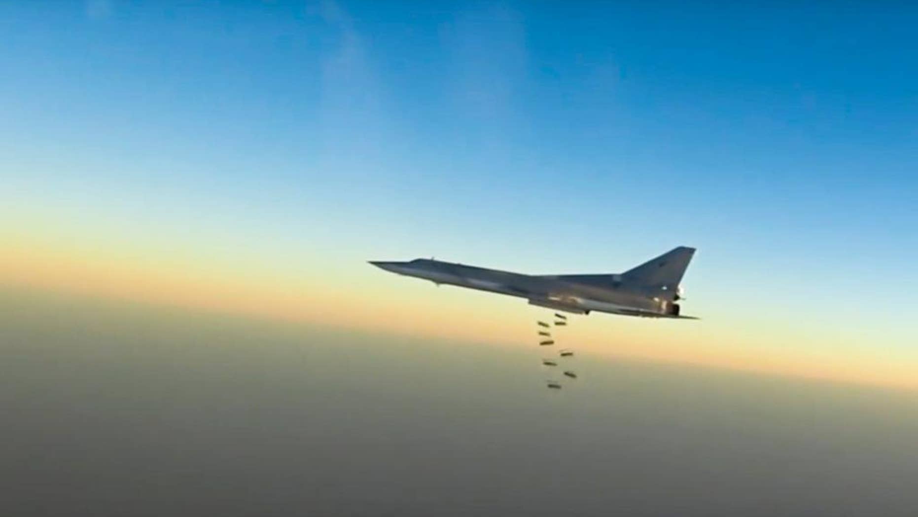In this frame grab from video provided by the Russian Defence Ministry Press Service, Russian long range bomber Tu-22M3 flies during a strike above an undisclosed location in Syria on Sunday, Aug. 14, 2015. ( Russian Defence Ministry press service photo via AP)