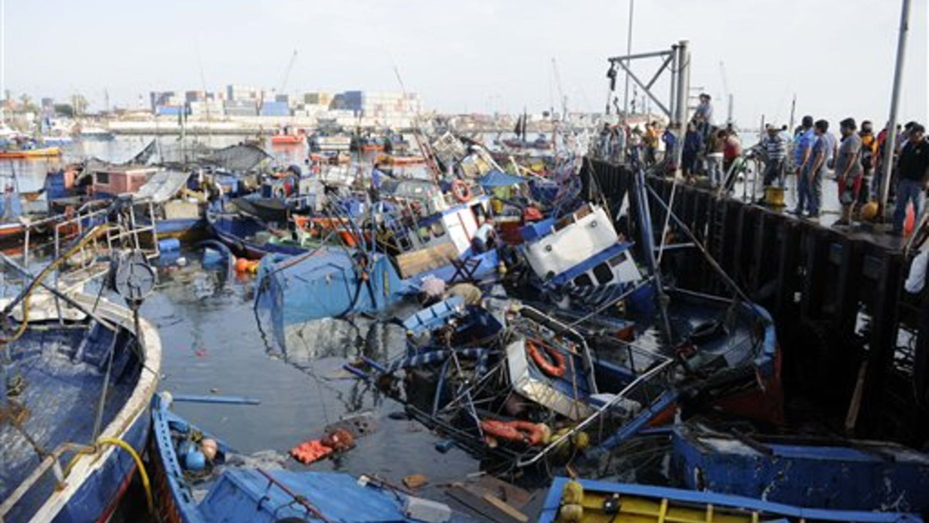 Fishing boats washed ashore by a small tsunami, sit in Caleta Riquelme, adjacent to the port, in the northern town of Iquique, Chile, after magnitude 8.2 earthqauke struck the northen coast of Chile, Wednesday, April 2, 2014. Authorities lifted tsunami warnings for Chiles long coastline early Wednesday. Six people were crushed to death or suffered fatal heart attacks, a remarkably low toll for such a powerful shift in the Earths crust. (AP Photo/Cristian Viveros) NO PUBLICAR EN CHILE
