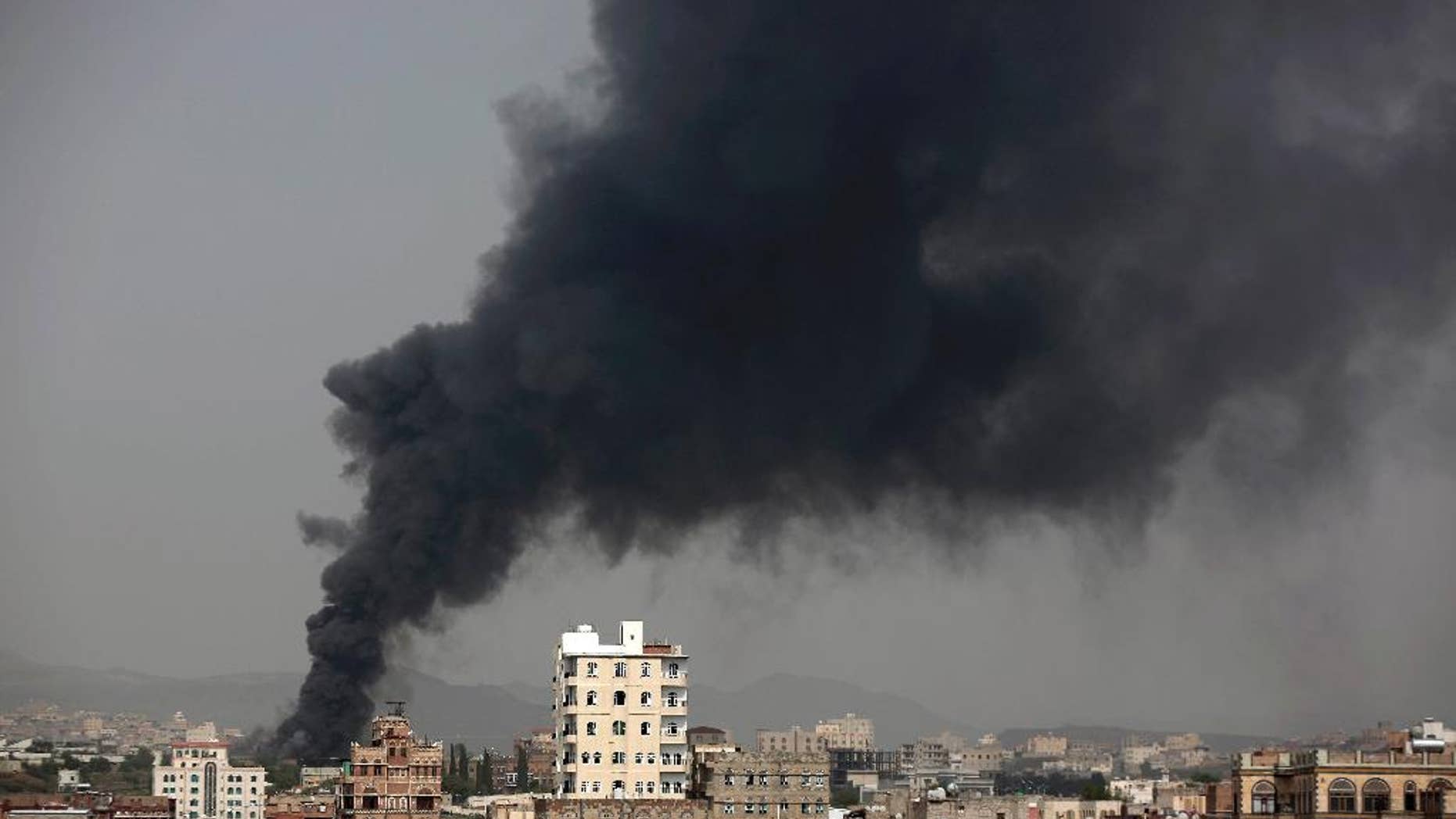 In this Aug. 9, 2016 photo, smoke rises after Saudi-led airstrikes hit a food factory in Sanaa, Yemen. In the air campaign by Saudi Arabia and its allies against Yemen’s Shiite rebels, rights experts say there has been a pattern by the Saudi-led coalition in depending on faulty intelligence, failing to distinguish between civilian and military targets and disregarding the likelihood of civilian casualties. Experts say some of the strikes likely amount to war crimes. (AP Photo/Hani Mohammed)
