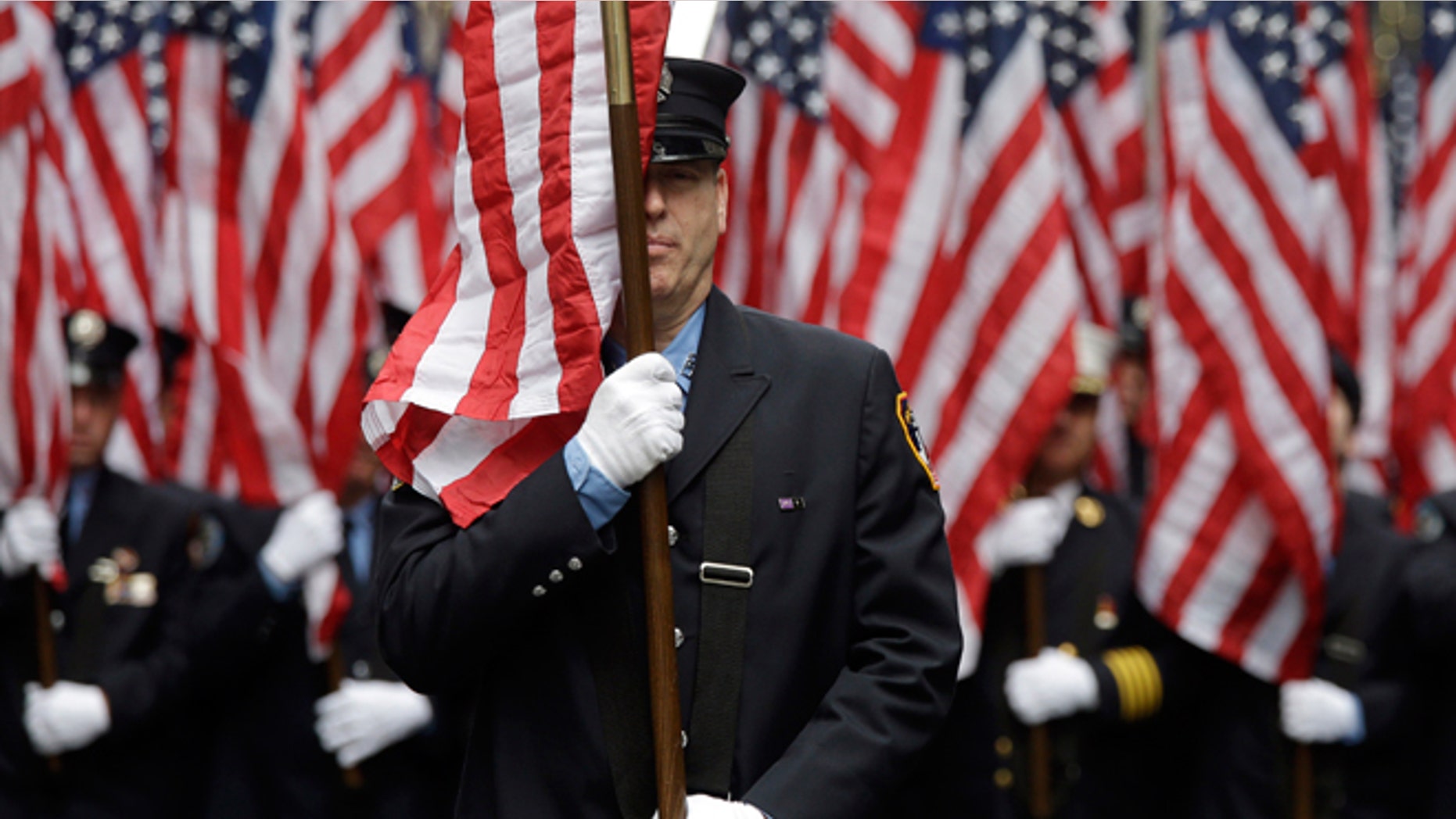 FILE -- March 17, 2015: Firefighters carrying 343 American flags representing each of their colleagues who died during the terrorist attacks on the World Trade Center, march up Fifth Ave. during the St. Patrick's Day Parade.
