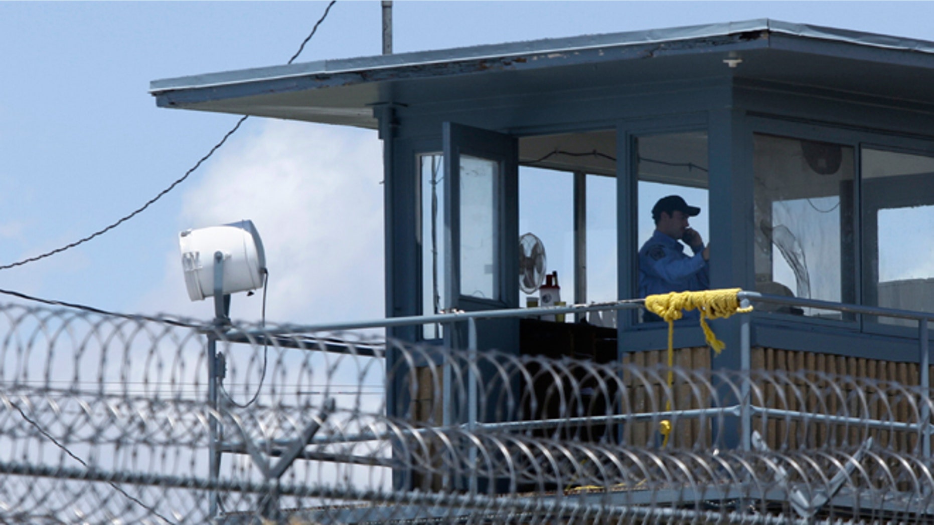 FILE - May 13, 2011: A guard sits in a tower at the Arkansas Department of Correction Tucker Unit near Tucker, Ark. Arkansas Gov. Asa Hutchinson on Feb. 18, 2015, detailed his effort to to reduce the backlog of more than 2,600 state inmates in county jails throughout Arkansas.