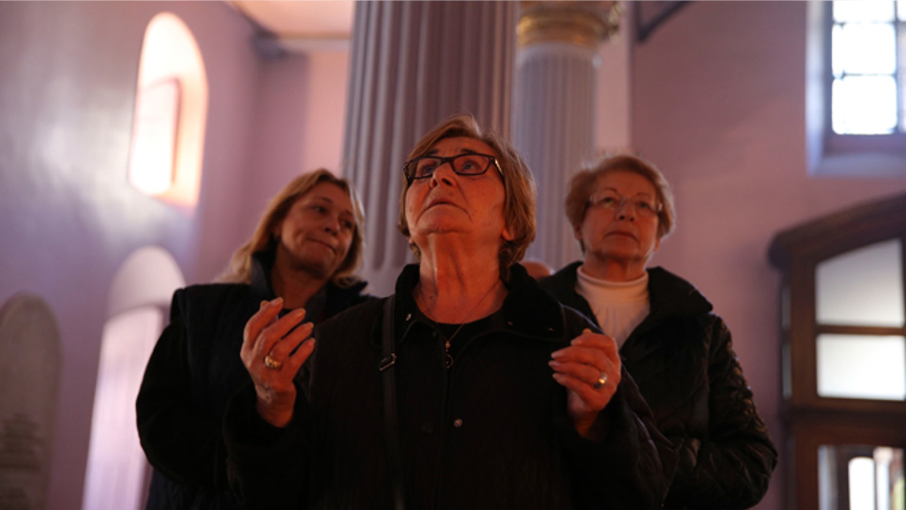 April 24, 2015: People pray during a commemoration service at the Armenian Patriarchate in Istanbul, Turkey. On Friday, Armenians mark the centenary of what historians estimate to be the slaughter of up to 1.5 million Armenians by Ottoman Turks, an event widely viewed by scholars as genocide. Turkey, however, denies the deaths constituted genocide and says the death toll has been inflated.