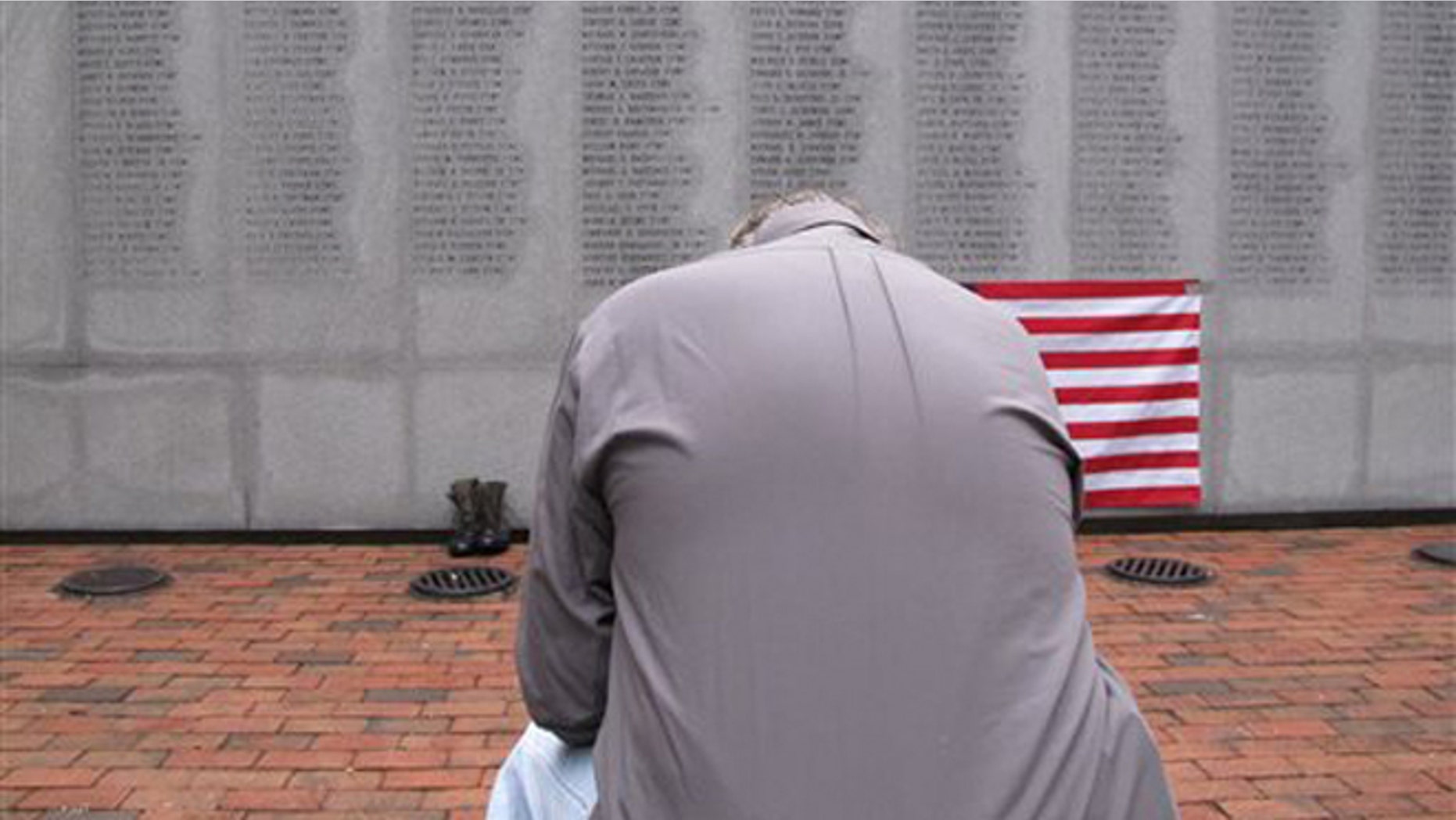 Oct. 23, 2013: Former Marine Ed Ayers of Scranton, Penn., hangs his head and weeps at the Beirut Bombing Memorial in Jacksonville, N.C. Wednesday was the 30th anniversary of a terrorist bombing that killed 241 U.S. service members. Ayers, who did two tours in Lebanon, said the peacekeeping mission there was worth it but, "I wish it was handled differently."