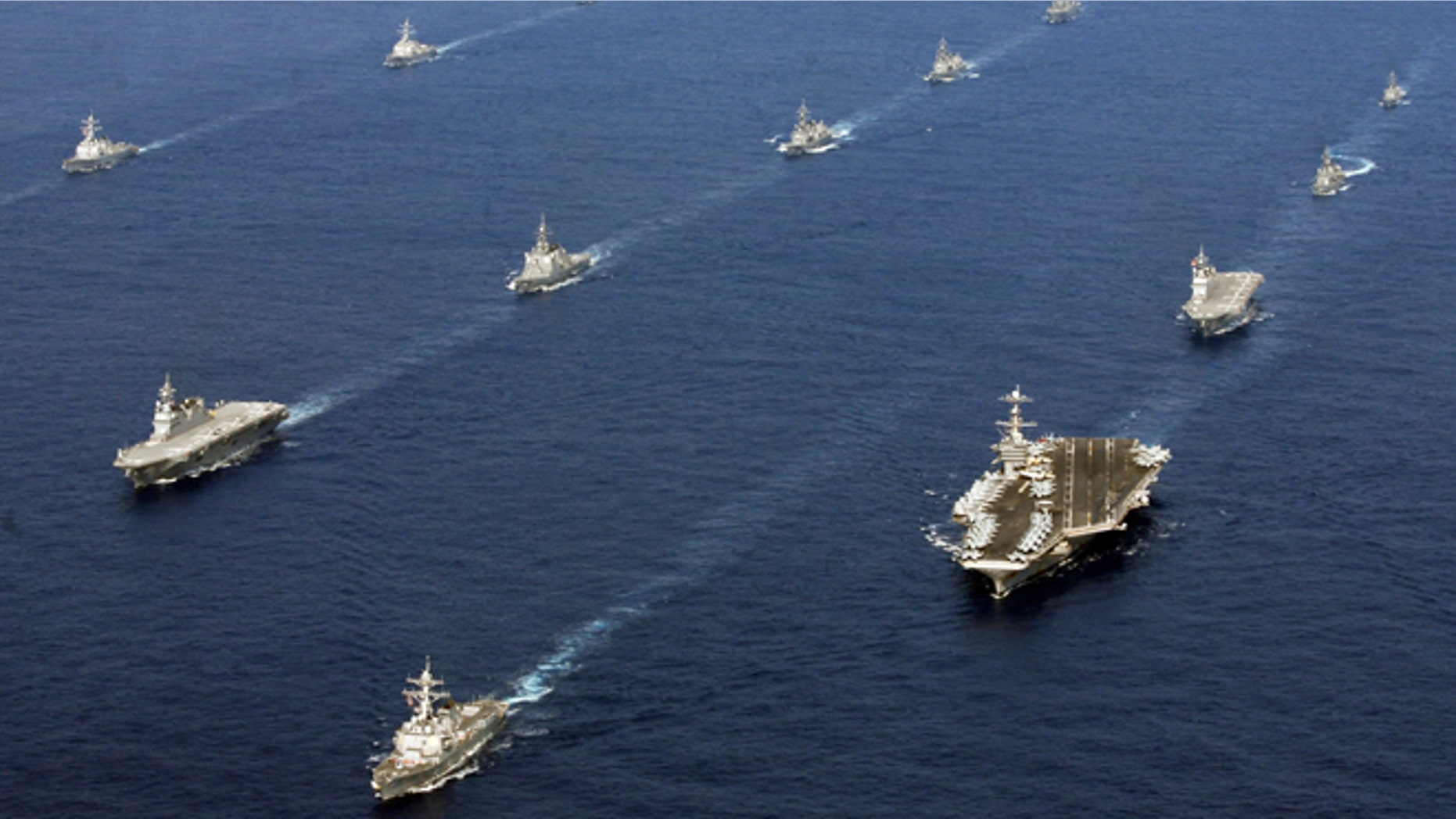 FILE -- Nov. 16, 2012: In this photo taken and released by U.S. Navy, twenty-six ships from the U.S. Navy and the Japan Maritime Self-Defense Force, including USS George Washington, bottom right, steam together in East China Sea after the conclusion of Keen Sword, a biennial naval exercise by the two countries to respond to a crisis in the Asia-Pacific region.