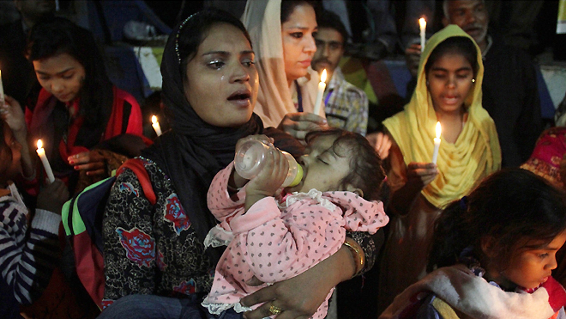 Nov. 12, 2014: Pakistani Christians hold candles to pay tribute to a slain Christian couple in Lahore, Pakistan. Police in Pakistan said they have arrested as many as 45 Muslims in connection with the killing of the Christian couple for allegedly desecrating the Koran. Under Pakistan's harsh blasphemy laws, anyone convicted of insulting Islam or the Prophet Muhammad can be sentenced to death. However, the laws are often misused to settle personal scores and target minorities.