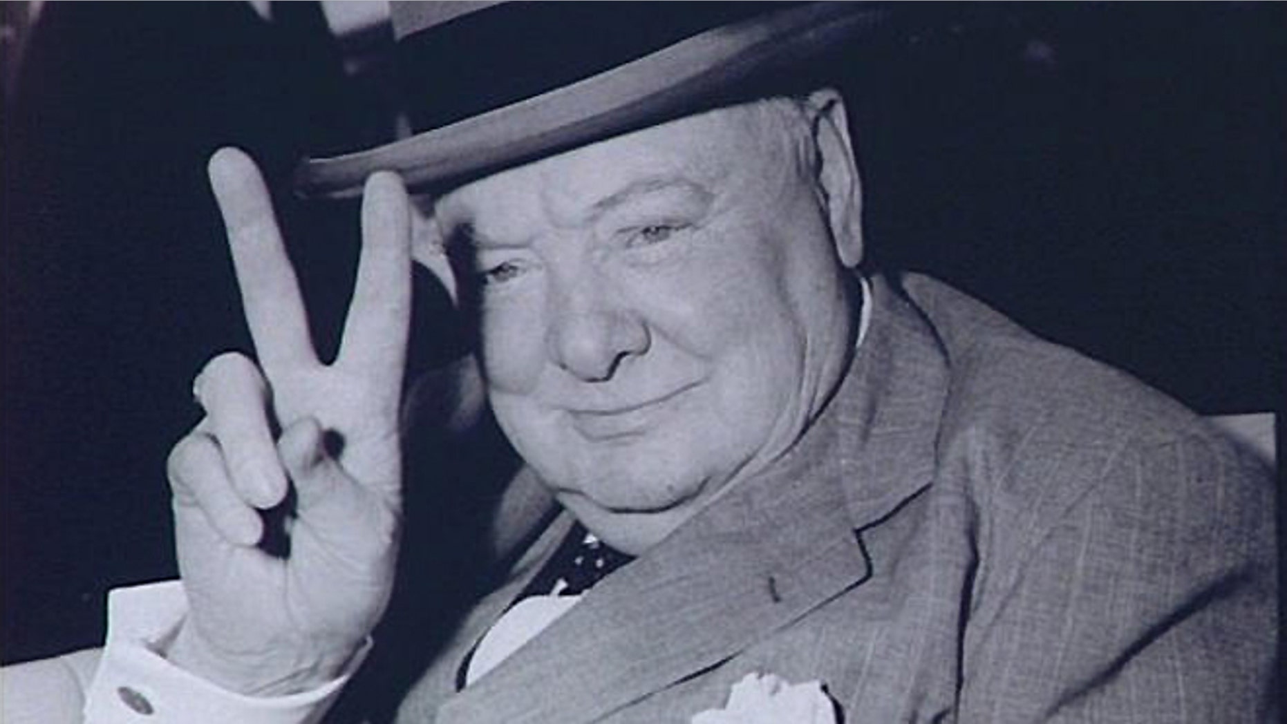 FILE -- May 25, 1954: Winston Churchill, British Prime Minister, gives V for Victory sign arriving in Washington, DC.