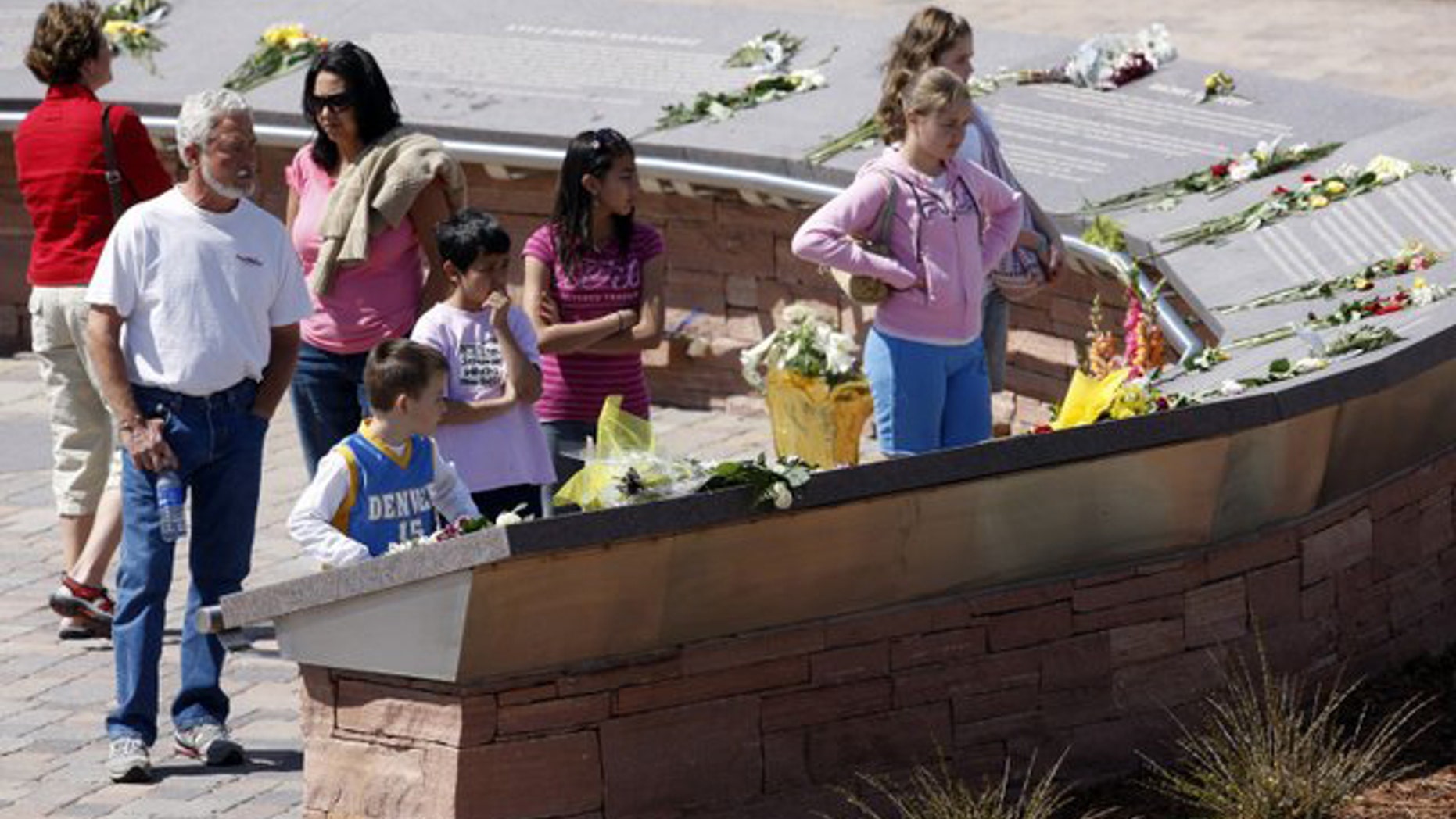 FILE -- April 20, 2009: Flowers are placed on the plaques to the 13 victims of the massacre at Columbine High School to mark the 10th anniversary of the killings, at Columbine Memorial in the southwest Denver suburb of Littleton, Colorado.