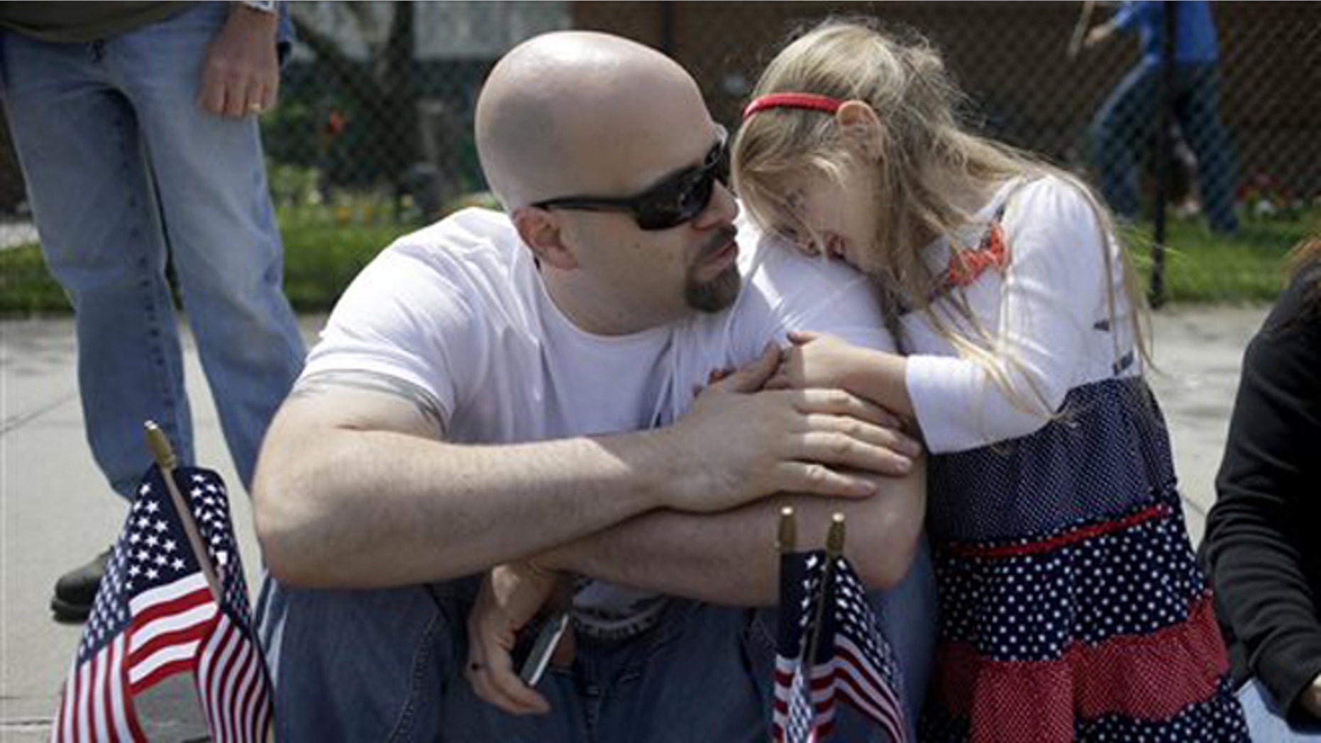 FILE -- Carol Brandt, 3, right, talks with her father Matthew Brandt during the College Point Memorial Day Parade in New York.