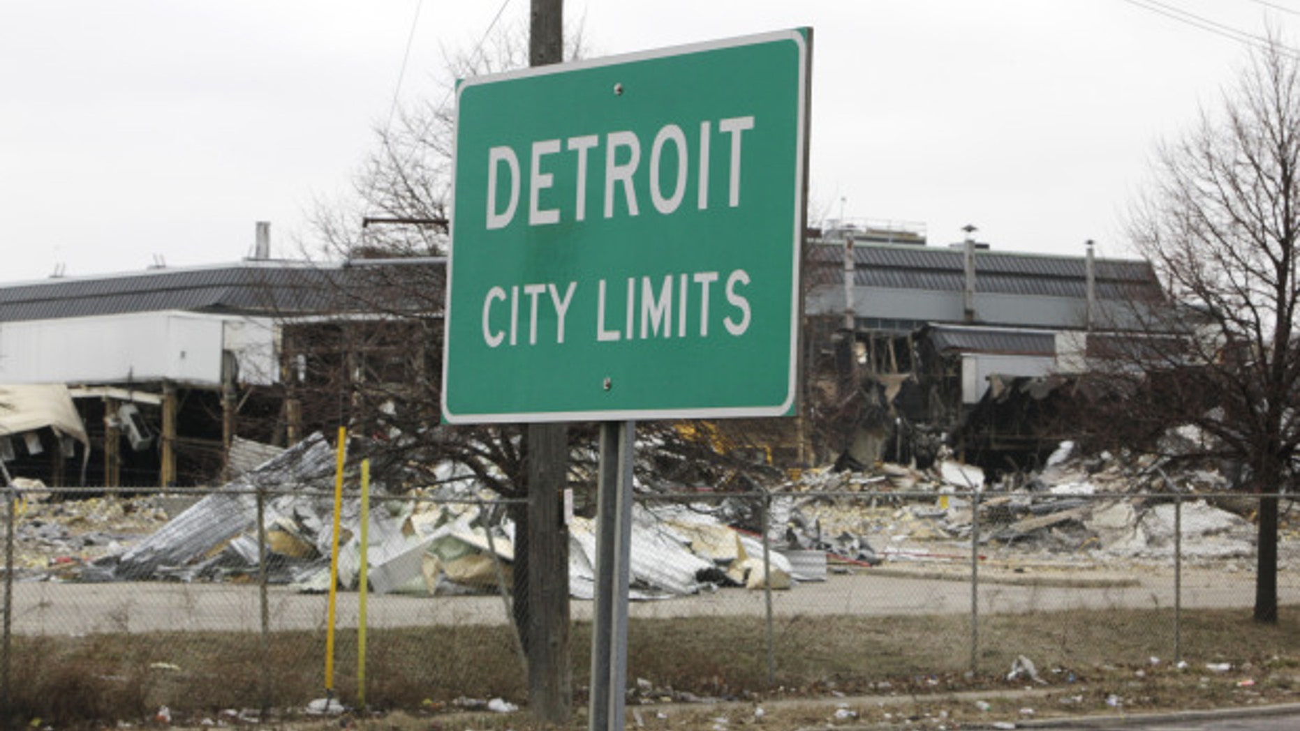FILE -- A street sign showing Detroit's city limits is shown near where a former Chrysler McGraw glass.