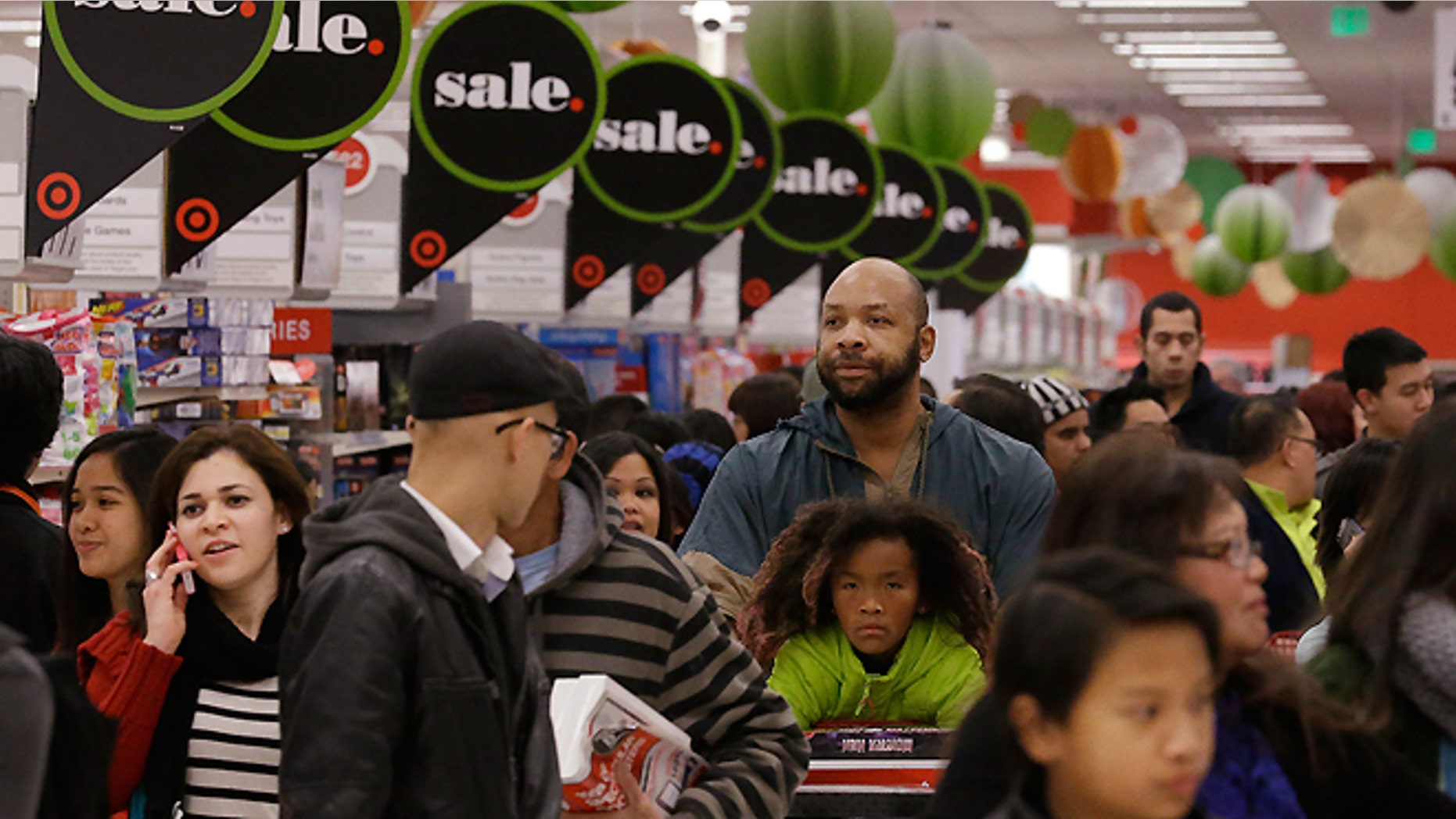FILE - In this Nov. 28, 2013 file photo, customers shop at a Target store in Colma, Calif.