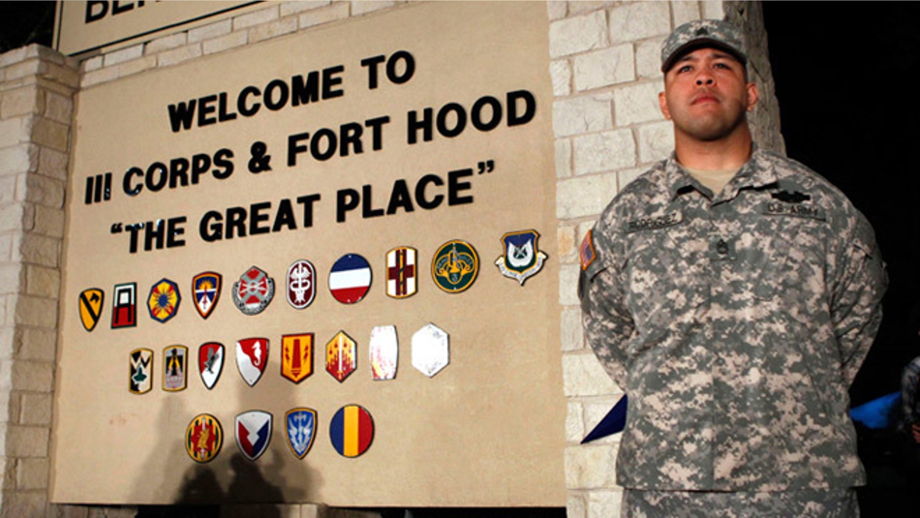 FILE -- April 2, 2014: Sgt. First Class Erick Rodriguez stands guard before a news conference by Lt. Gen. Mark Milley at the entrance to Fort Hood Army Post in Texas.