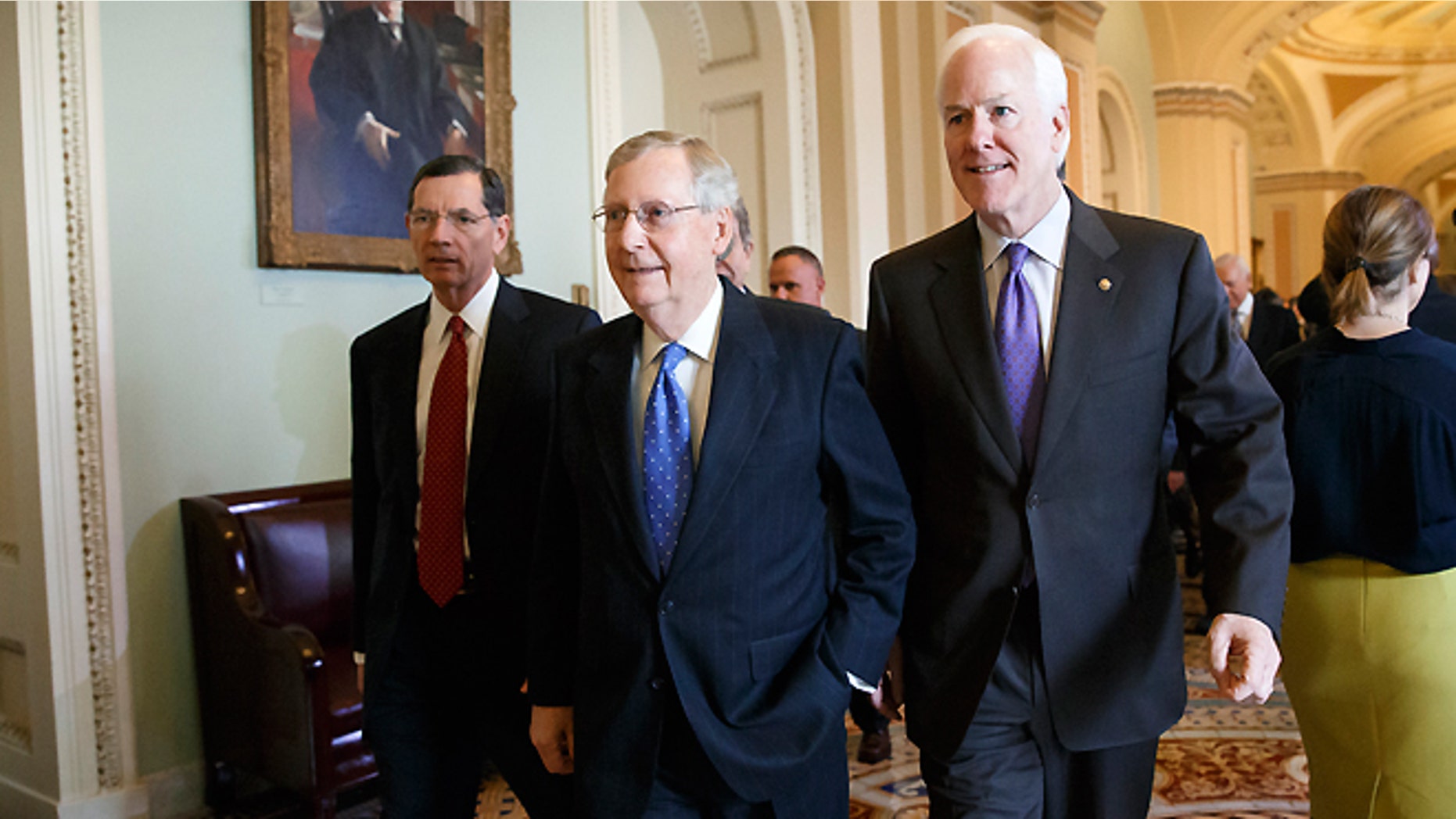 FILE -- Nov. 13, 2014: Senate Minority Leader Mitch McConnell of Ky., flanked by Sen. John Barrasso, R-Wyo., left, and Senate Minority Whip John Cornyn of Texas, emerges from a closed-door meeting on Capitol Hill in Washington, where he was chosen by acclamation of the GOP rank-and-file to be the new Senate majority leader when the new Congress convenes in January.