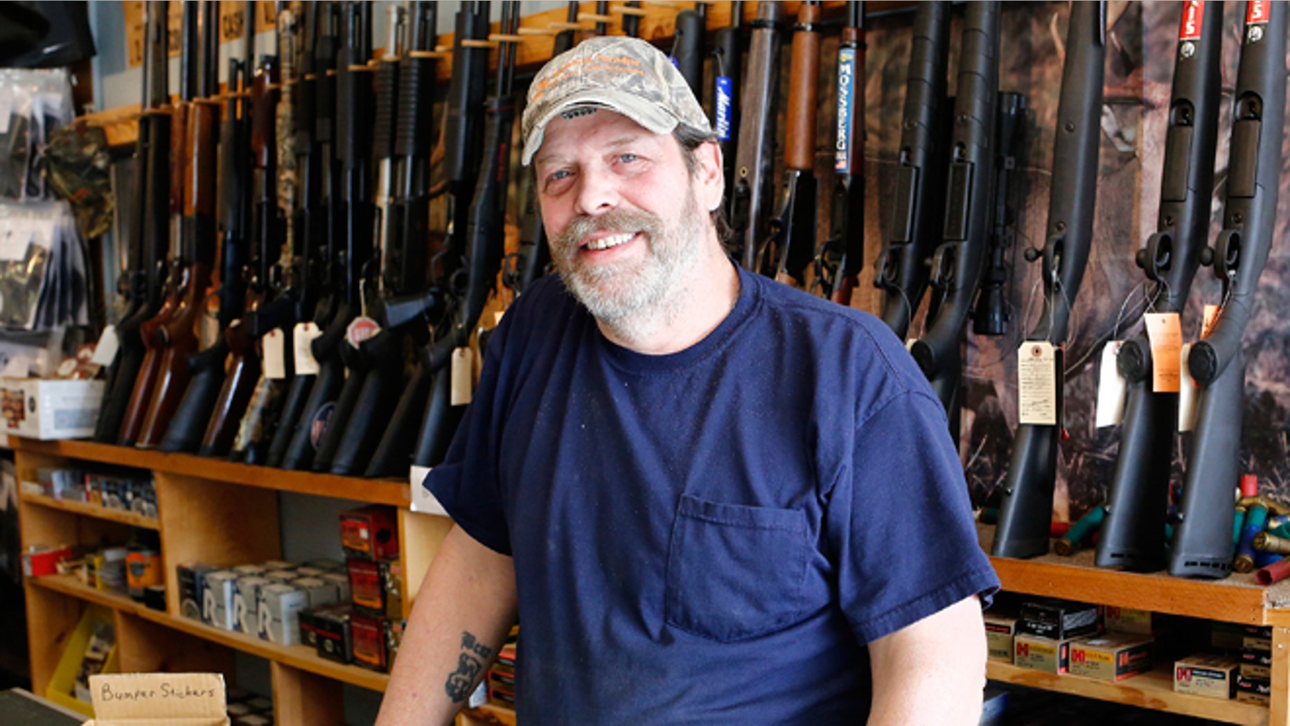 FILE -- March 31, 2015: Shooter's Paradise owner Paul Barrett stands inside his store in Sioux City, Iowa.