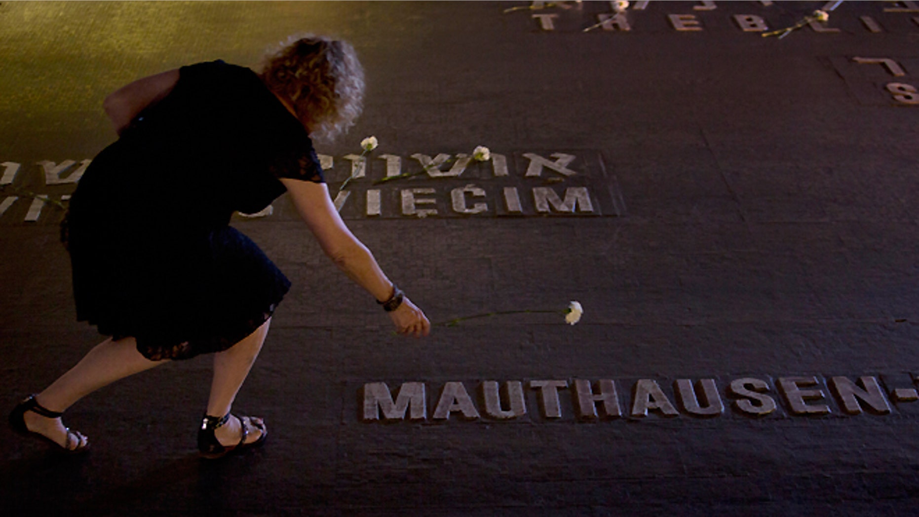 FILE -- April 28, 2014: Relatives of Holocaust victims lay flowers next to the names of concentration camps during a ceremony marking the annual Holocaust Remembrance Day at the Yad Vashem Holocaust Memorial in Jerusalem.