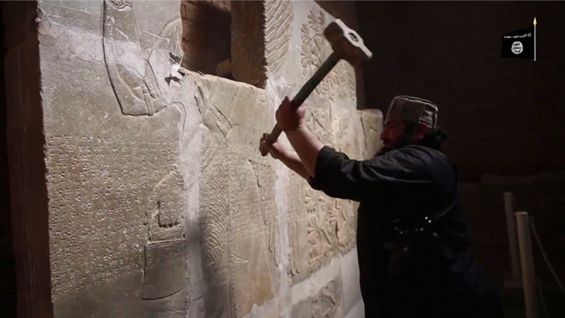April 11, 2015: In this image made from video posted on a militant social media account affiliated with the Islamic State group purports to show a militant taking a sledgehammer to an Assyrian relief at the site of the ancient Assyrian city of Nimrud, which dates back to the 13th century B.C., near the militant-held city of Mosul, Iraq. The destruction at Nimrud, follows other attacks on antiquity carried out by the group now holding a third of Iraq and neighboring Syria in its self-declared caliphate. The attacks have horrified archaeologists and U.N. Secretary-General Ban Ki-moon, who last month called the destruction at Nimrud "a war crime."