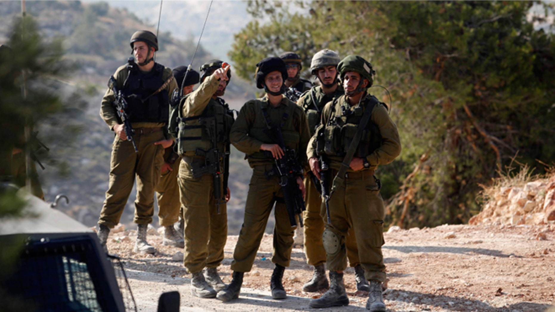 Israeli soldiers deploy near the West Bank city of Hebron, Friday, June 13, 2014. Israeli soldiers searched the West Bank on Friday for three missing teenagers from nearby settlements, one of them a U.S. citizen, amid fears Palestinian militants abducted them, authorities said.
