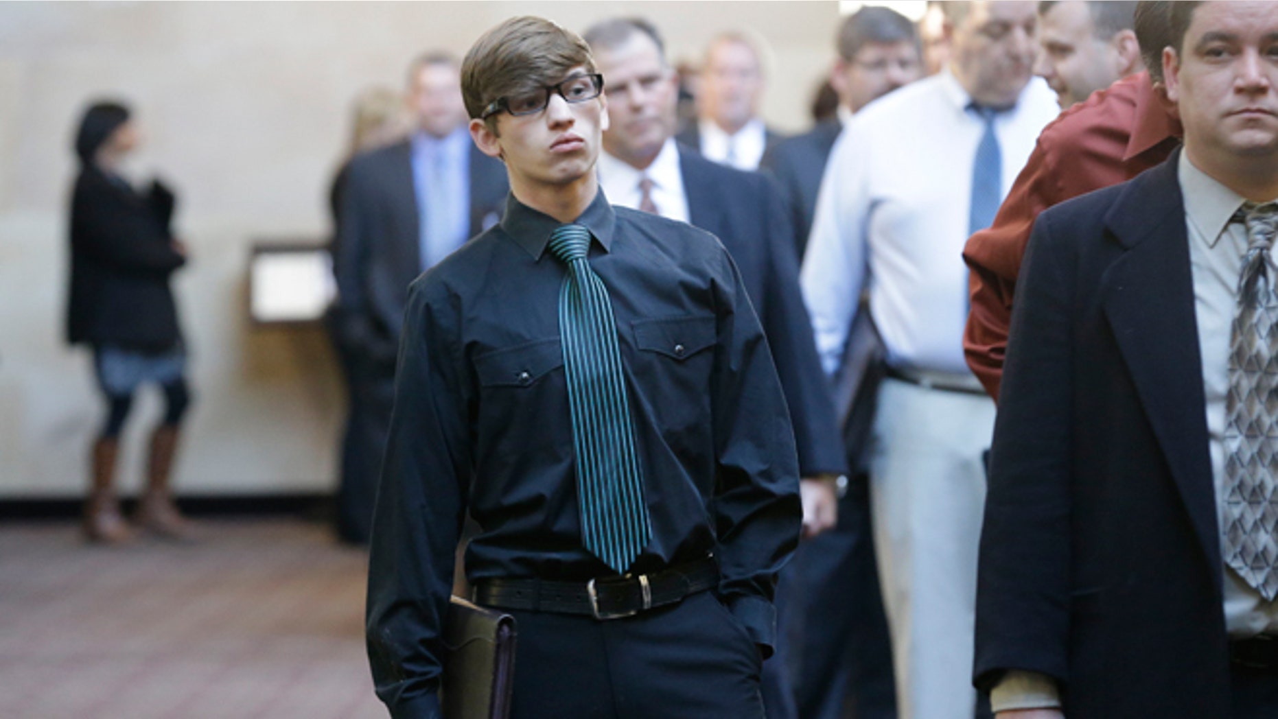 FILE -- Jan. 22, 2014: Austin Moore, 18, lines up with other job seekers during a career fair at a hotel in Dallas.