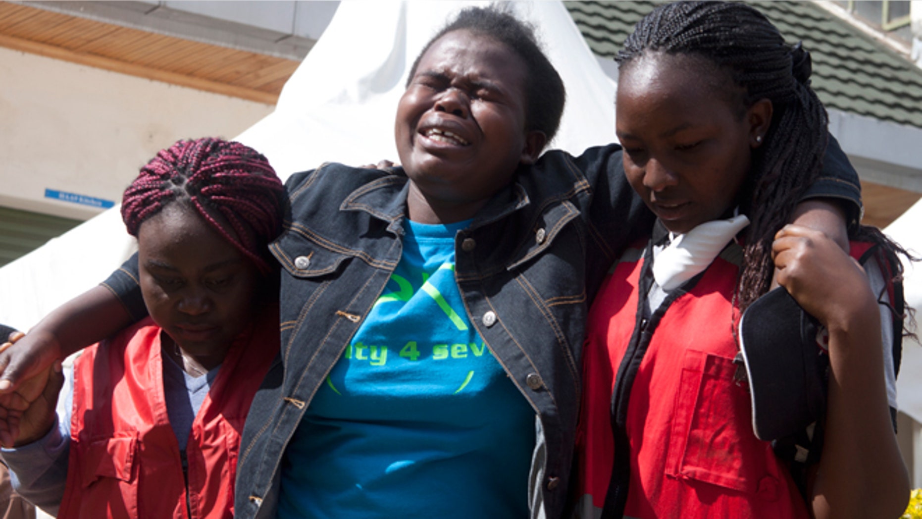 April 8, 2015: Kenya Red Cross staff help a woman after she viewed the body of a relative killed in last Thursday's attack on Garissa University College in northeastern Kenya, at Chiromo funeral home, Nairobi, Kenya. Al-Shabab gunmen rampaged through the university at dawn Thursday, killing over 140 people in the group's deadliest attack in the East African country.