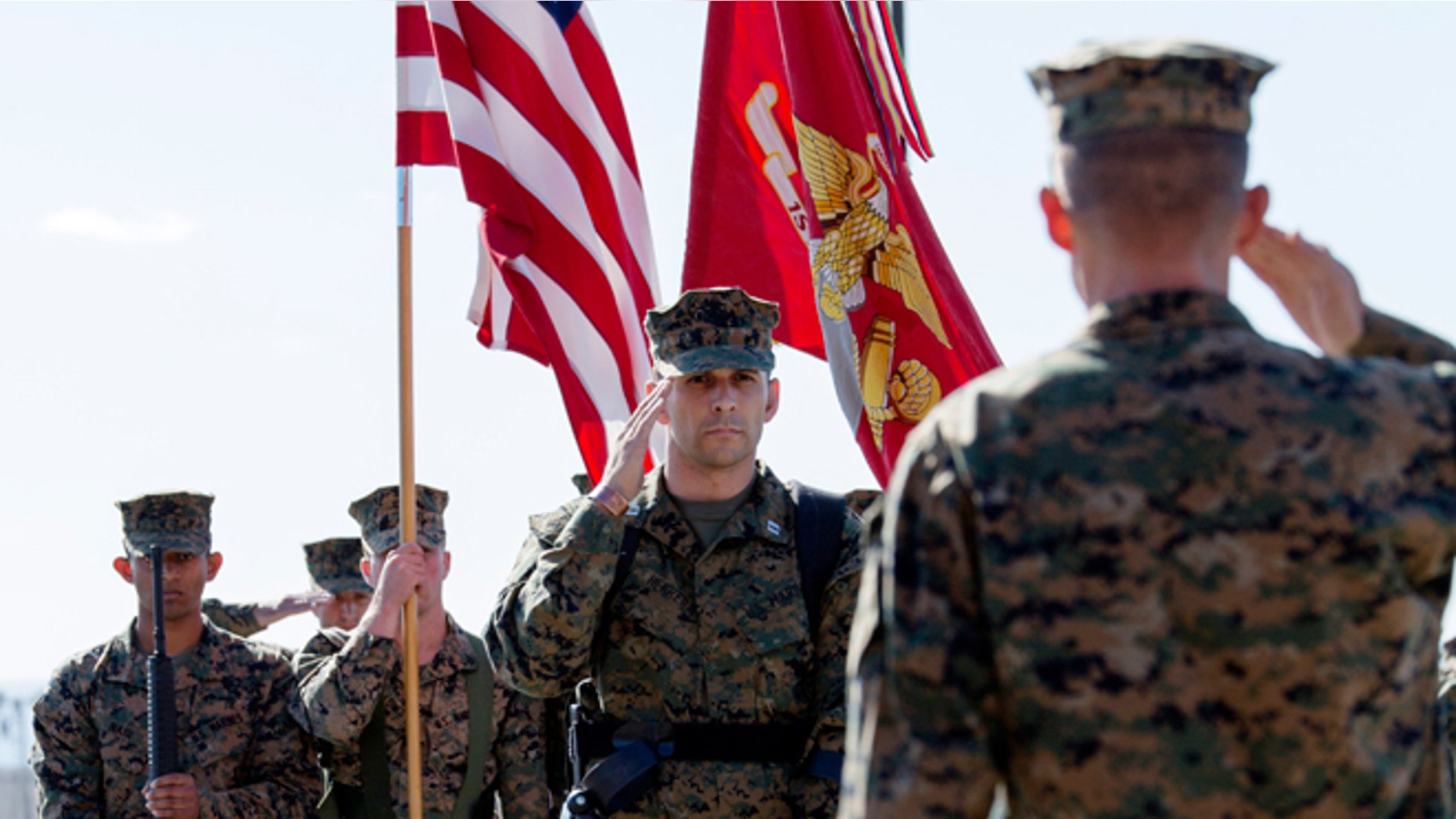Nov. 21, 2014: In this photo provided by the U.S. Marines, U.S. Marine Capt. Derek Herrera, center, 1st Marine Special Operations Battalion, salutes during his awards and retirement ceremony at Camp Pendleton, Calif.