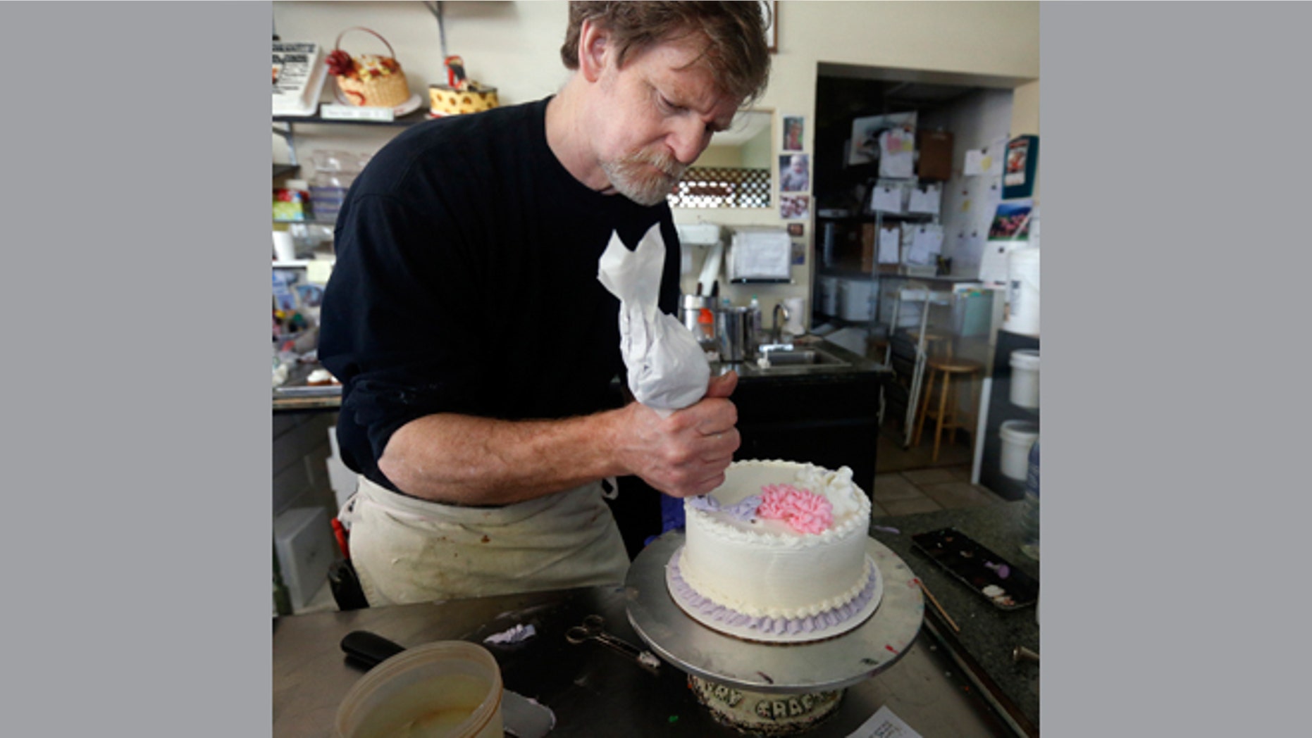 File: March 10, 2014: Masterpiece Cakeshop owner Jack Phillips decorates a cake inside his store, in Lakewood, Colo.