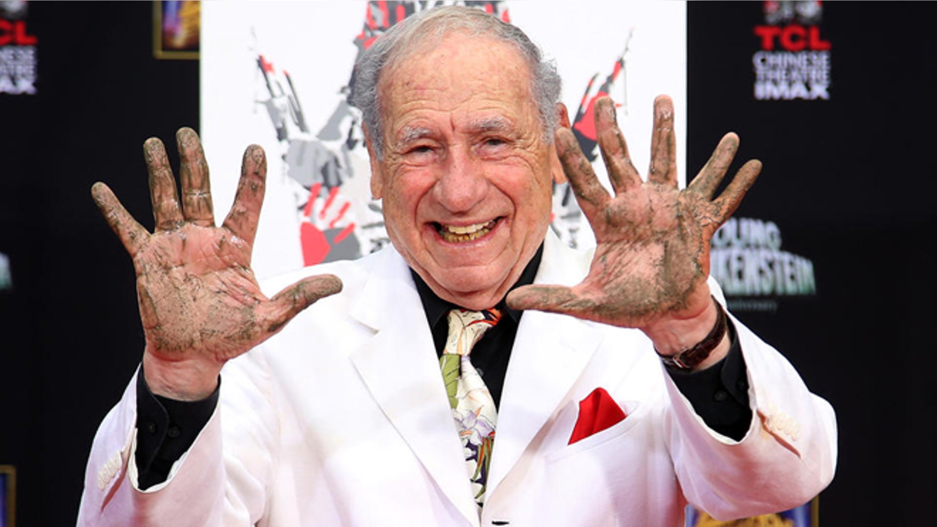 FILE -- Sept. 8, 2014: Director/Comedian Mel Brooks displays his cement-covered hands, including one with a prosthetic finger, during his Hand and Footprint ceremony marking the 40th anniversary of the movie "Young Frankenstein," in front of the TCL Chinese Theatre in the Hollywood section of Los Angeles.
