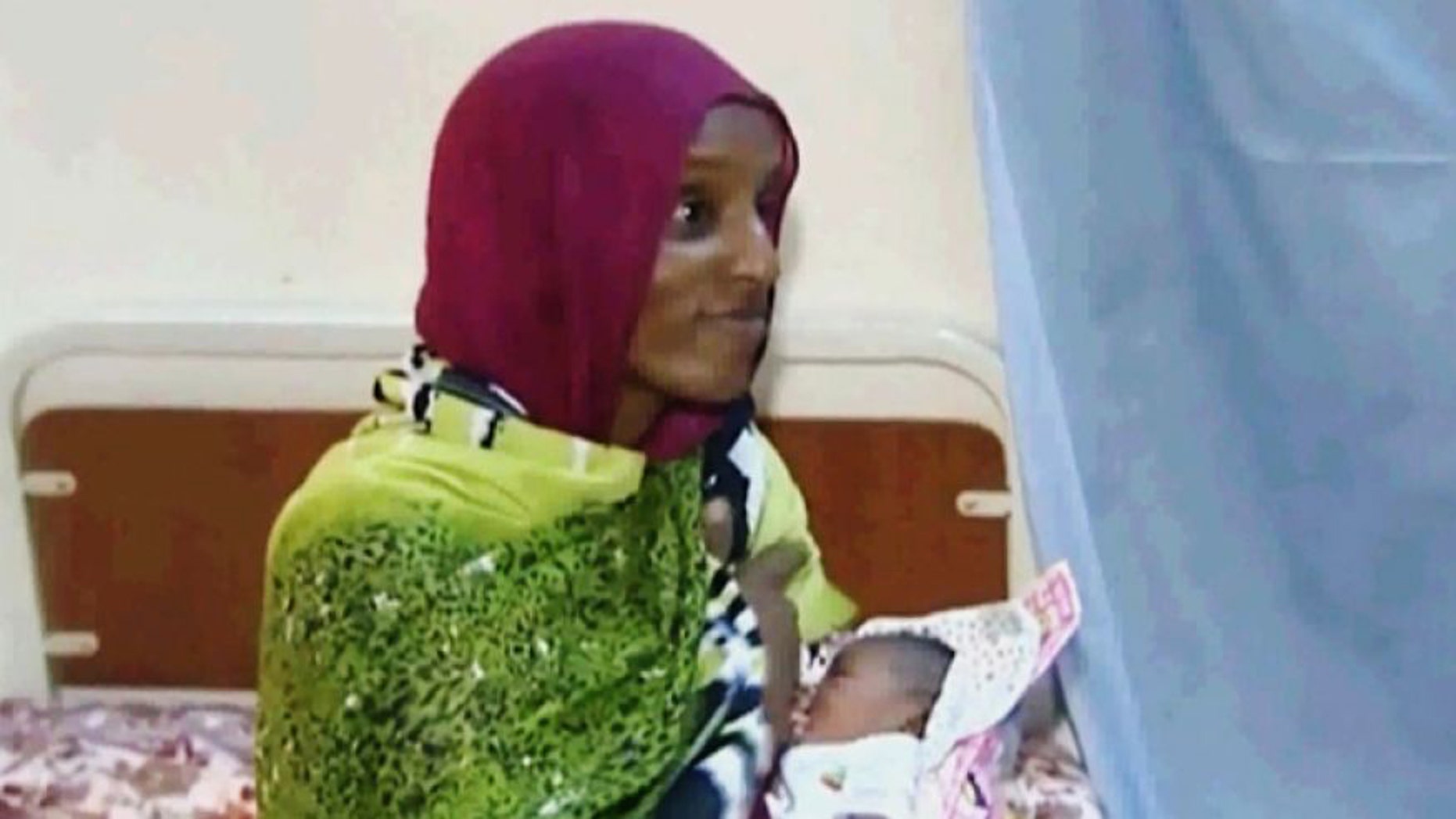 June 5, 2014: In this file image made from an undated video provided by Al Fajer, a Sudanese nongovernmental organization, Meriam Ibrahim breastfeeds her newborn baby girl as the NGO visits her in a room at a prison in Khartoum, Sudan. (AP)