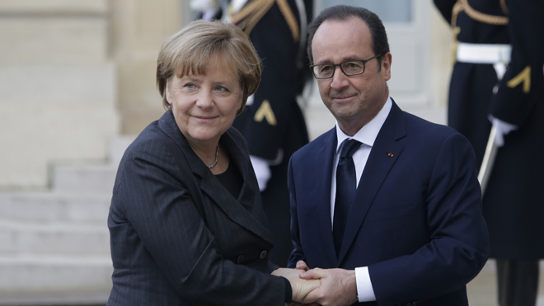 Jan. 11, 2015: French President Francois Hollande welcomes German Chancellor Angela Merkel, left, as she arrives at the Elysee Palace, Paris.