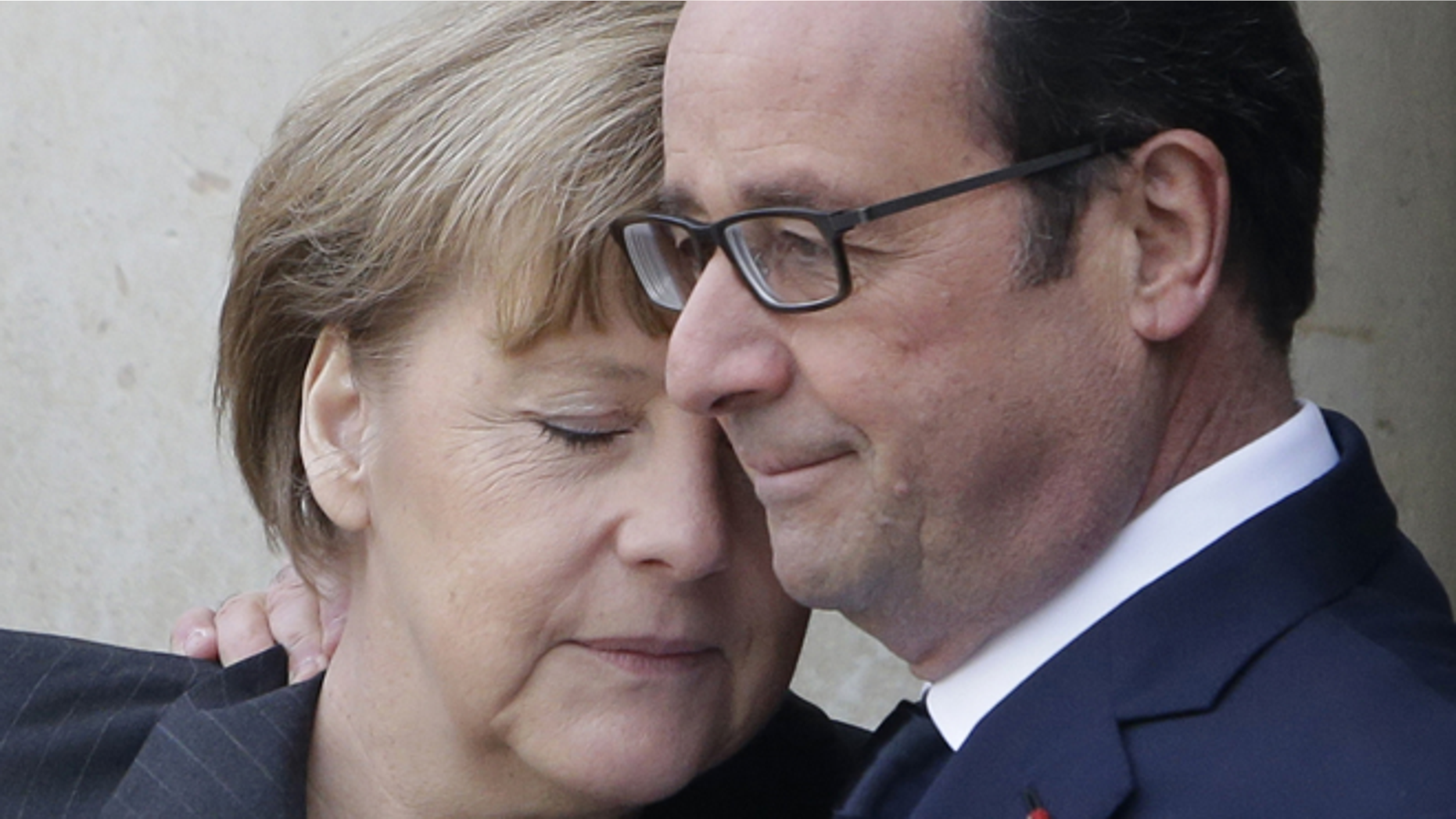 FILE -- Jan. 11, 2015: French President Francois Hollande embraces German Chancellor Angela Merkel, left, as she arrives at the Elysee Palace, Paris. A rally of defiance and sorrow, protected by an unparalleled level of security, on Sunday will honor the 17 victims of three days of bloodshed in Paris that left France on alert for more violence.