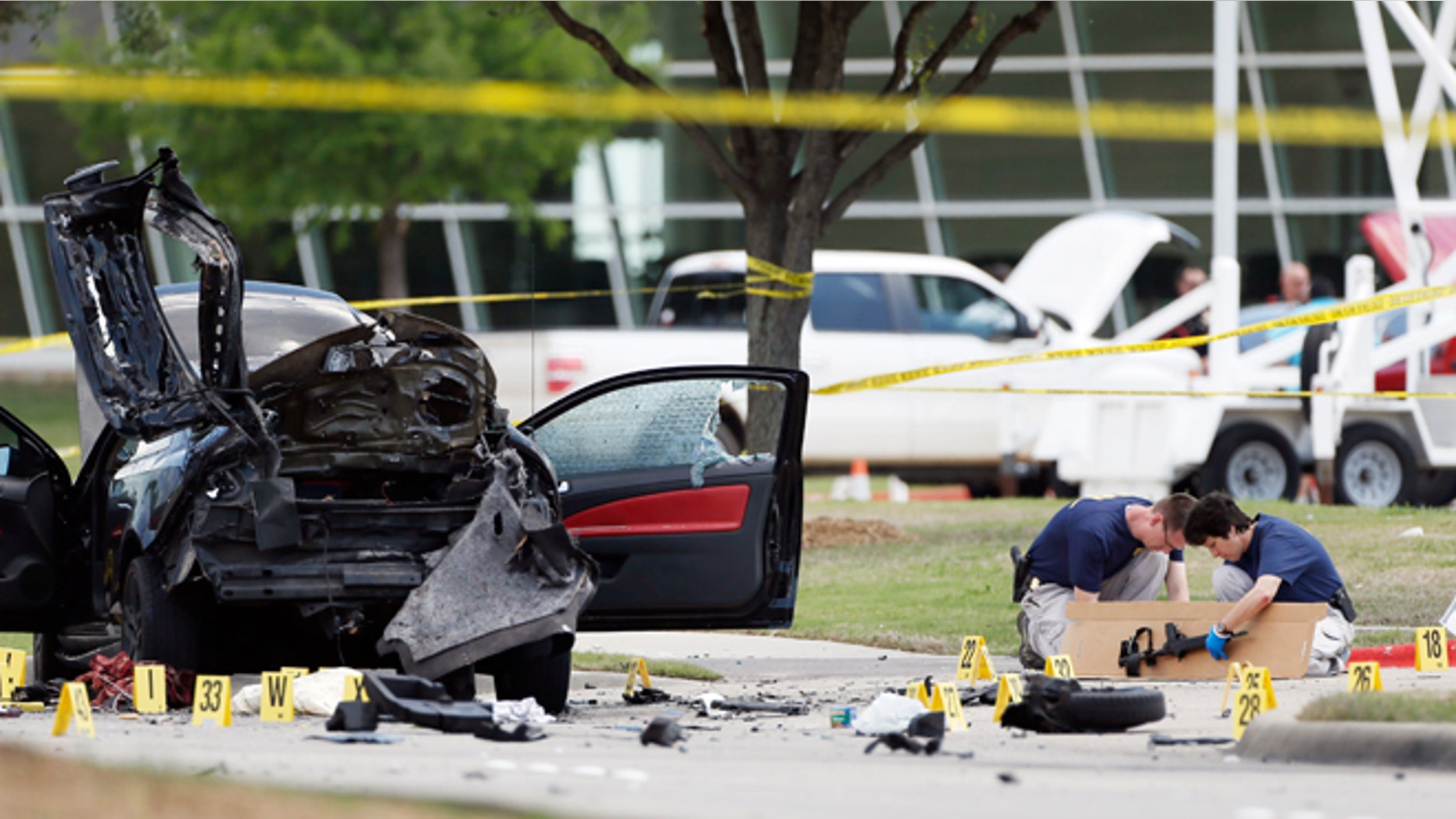 May 4, 2015: Investigators box up an assault weapon outside the Curtis Culwell Center in Garland, Texas. Two men opened fire with assault weapons on police Sunday night who were guarding a provocative contest for Prophet Muhammed cartoons. A police officer returned fire killing both men.