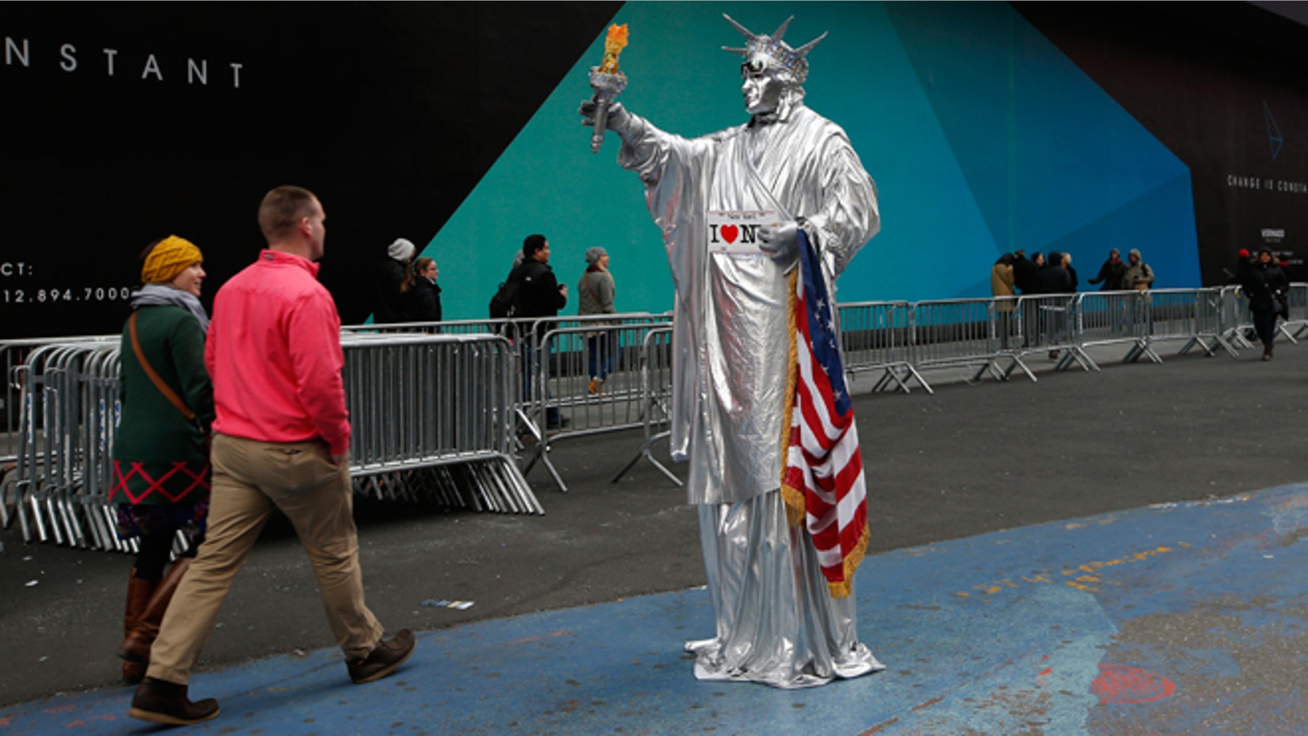 Dec. 30, 2014: A costumed character dressed as the Statue of Liberty stands in a quiet area of Times Square in New York.
