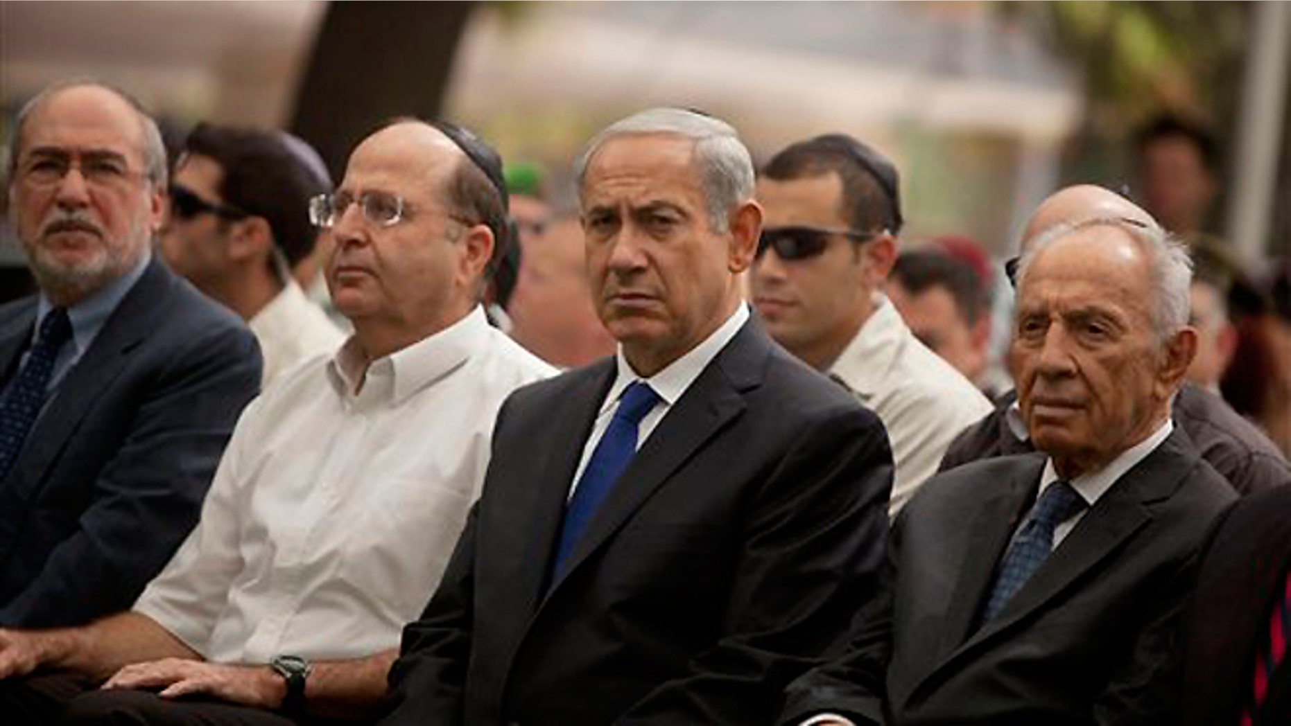 FILE -- Sept. 15, 2013: Israeli Prime Minister Benjamin Netanyahu, center, sits with Israeli President Shimon Peres, right, and Israeli Defense Minister Moshe Yaalon during the state memorial ceremony for soldiers, fallen during the 1973 Arab-Israel War, which Israelis call the Yom Kippur War, in Jerusalem.