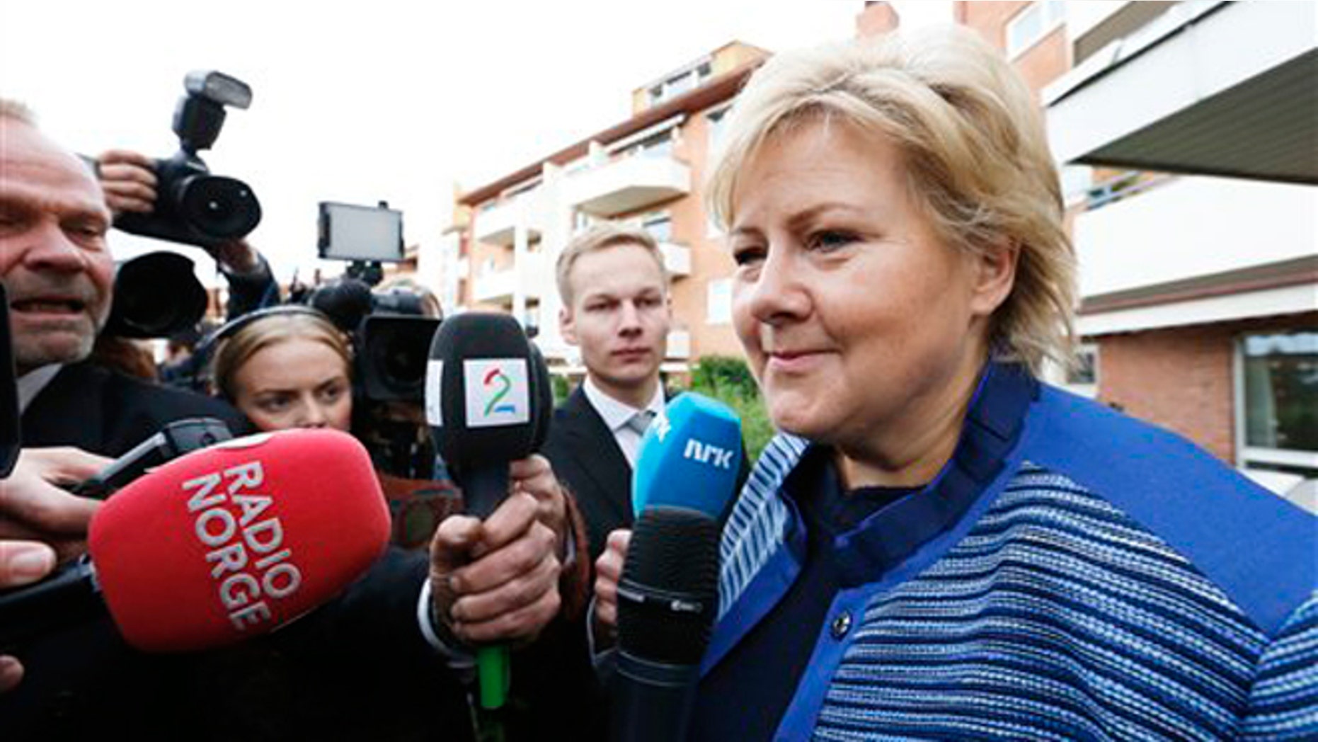 Sept. 10, 2013: Chairman of the Conservative Party in Norway, Erna Solberg, meets the press outside the block of apartments where she lives in Oslo the day after she and her party returned a resounding victory in the general elections. Solberg nicknamed "Iron Erna" will become Norway's new prime minister as the leader of a center-right coalition government likely including an anti-immigration party.