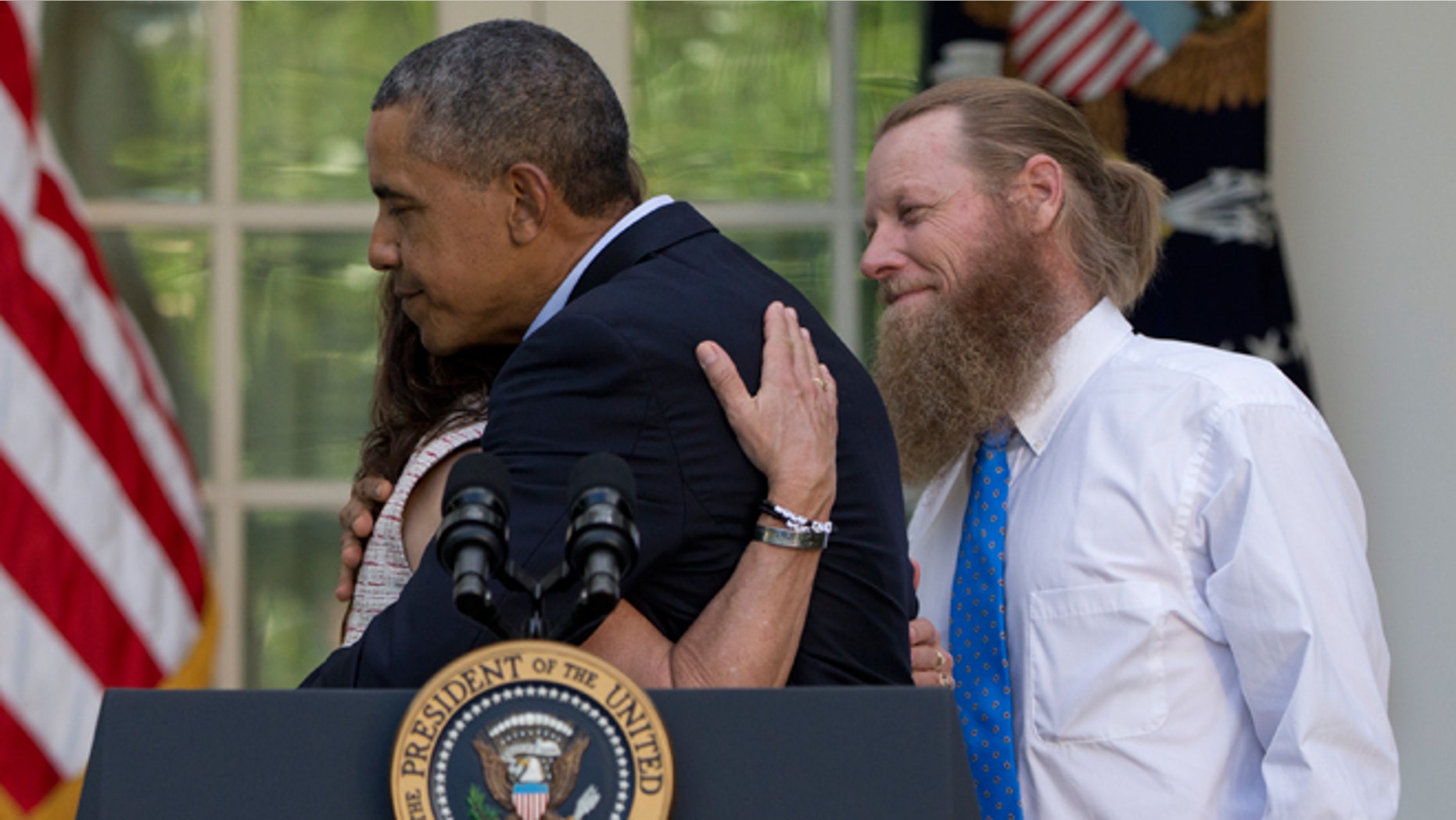 President Obama hugs Jani Bergdahl, as Bob Bergdahl, stands at right, during a news conference in the Rose Garden of the White House in Washington, Saturday, May 31, 2014 about the release of their son, U.S. Army Sgt. Bowe Bergdahl, from captivity. Bergdahl, 28, had been held prisoner by the Taliban since June 30, 2009. He was handed over to U.S. special forces by the Taliban in exchange for the release of five Afghan detainees held by the United States.