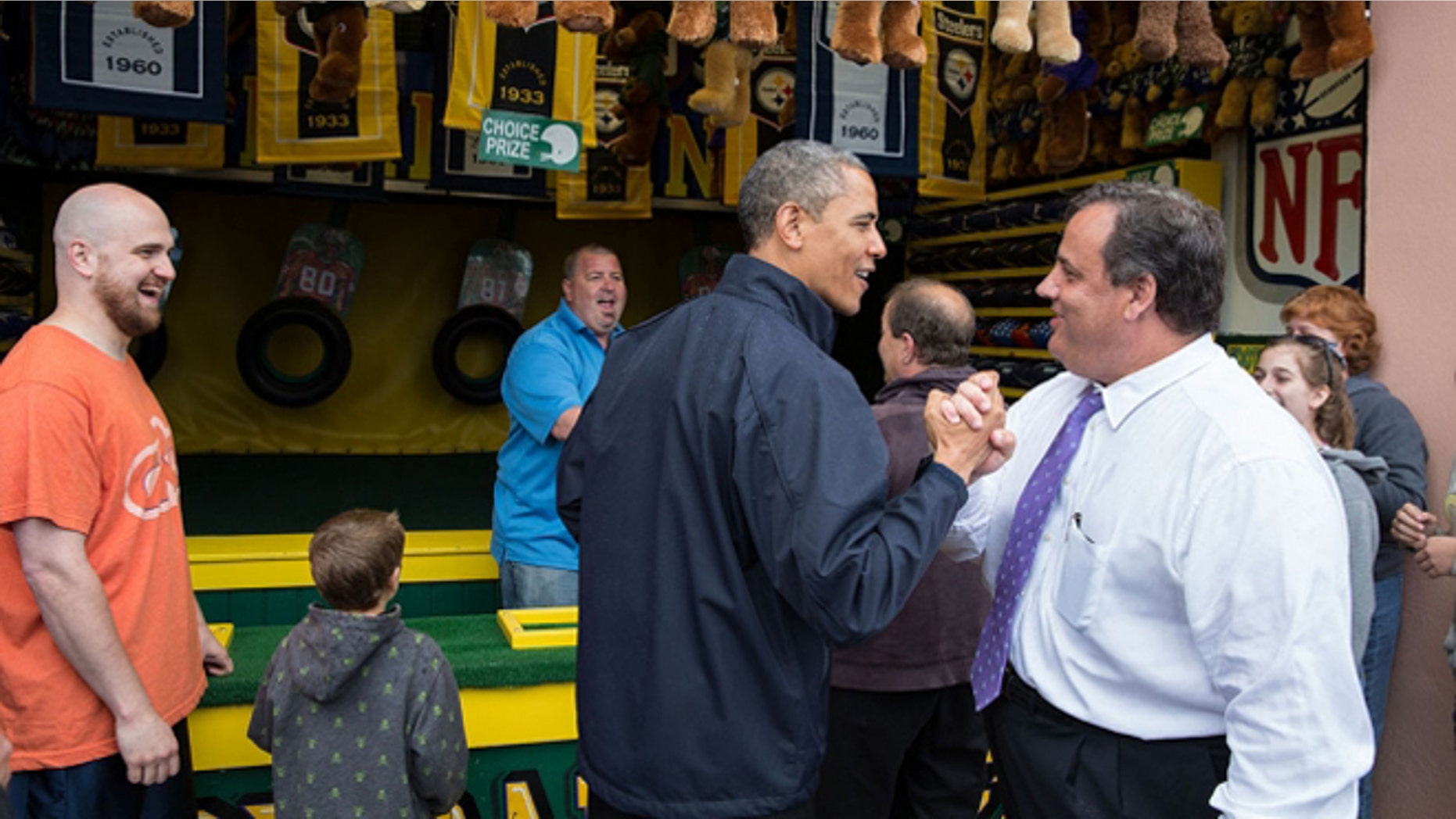 FILE -- May 28, 2013: President Obama congratulates New Jersey Governor Chris Christie while playing the "TouchDown Fever" arcade game along the Point Pleasant boardwalk in Point Pleasant Beach, N.J.