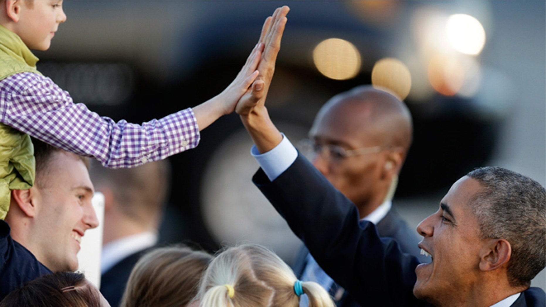Feb. 12, 2015: President Obama high five's a boy upon his arrival at San Francisco International Airport in San Francisco.